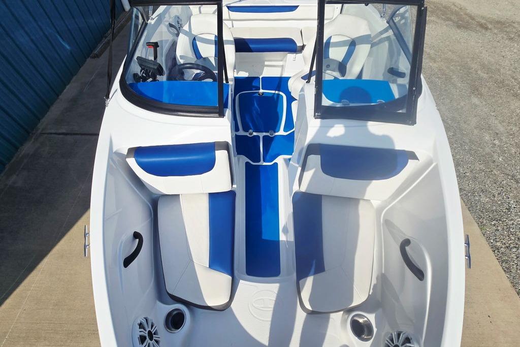 2018 Tahoe 450 TS boat interior with blue and white seating, open windshield, and modern design.