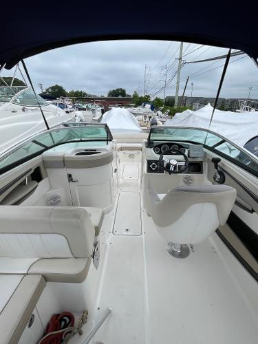 2013 Sea Ray 240 Sundeck interior with helm, seating, and dashboard.