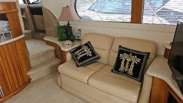 Interior of 2000 Carver 450 Voyager Pilothouse with beige sofa and decorative pillows.