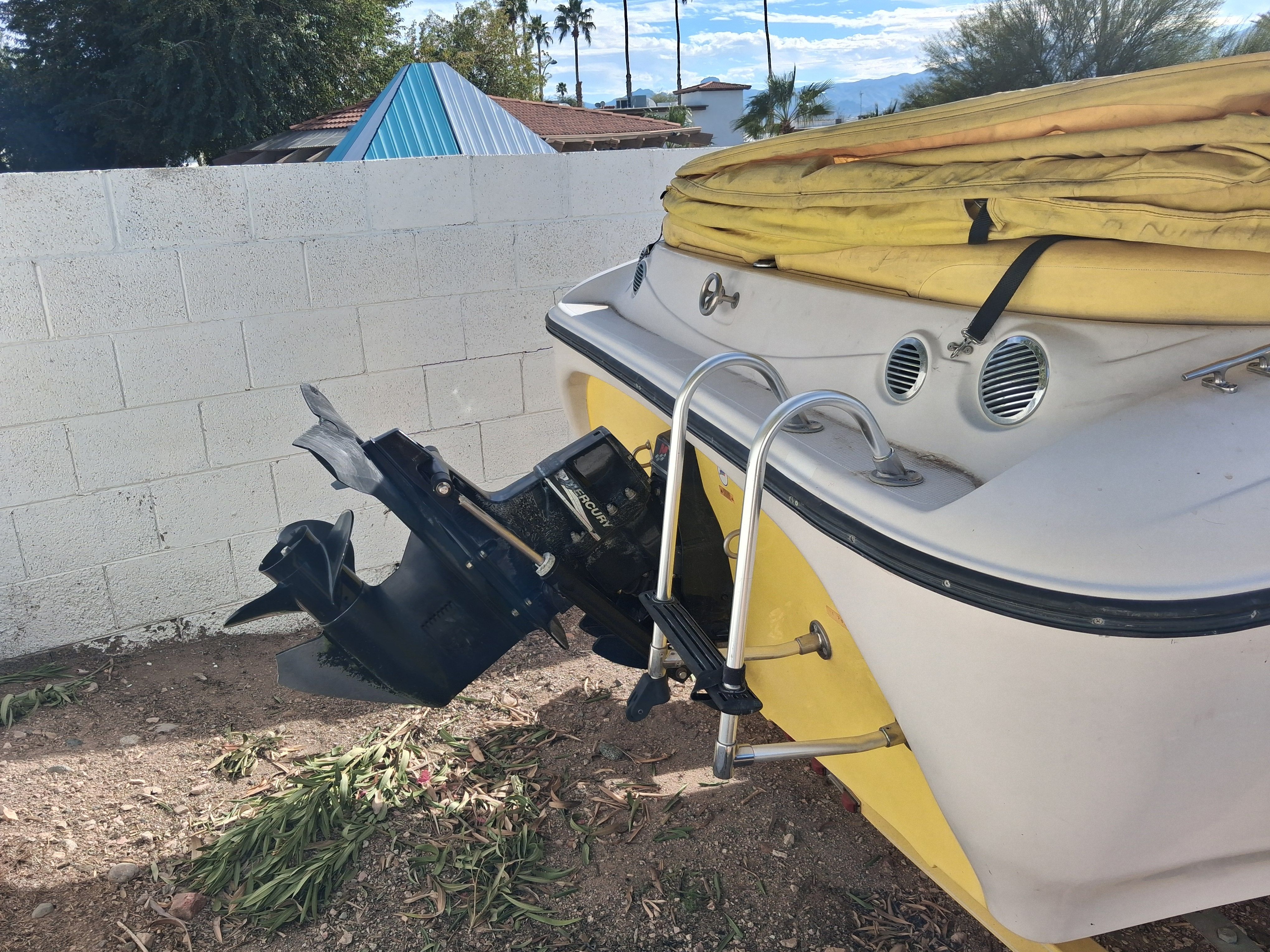 2004 Tracker Tahoe boat with outboard motor and ladder.
