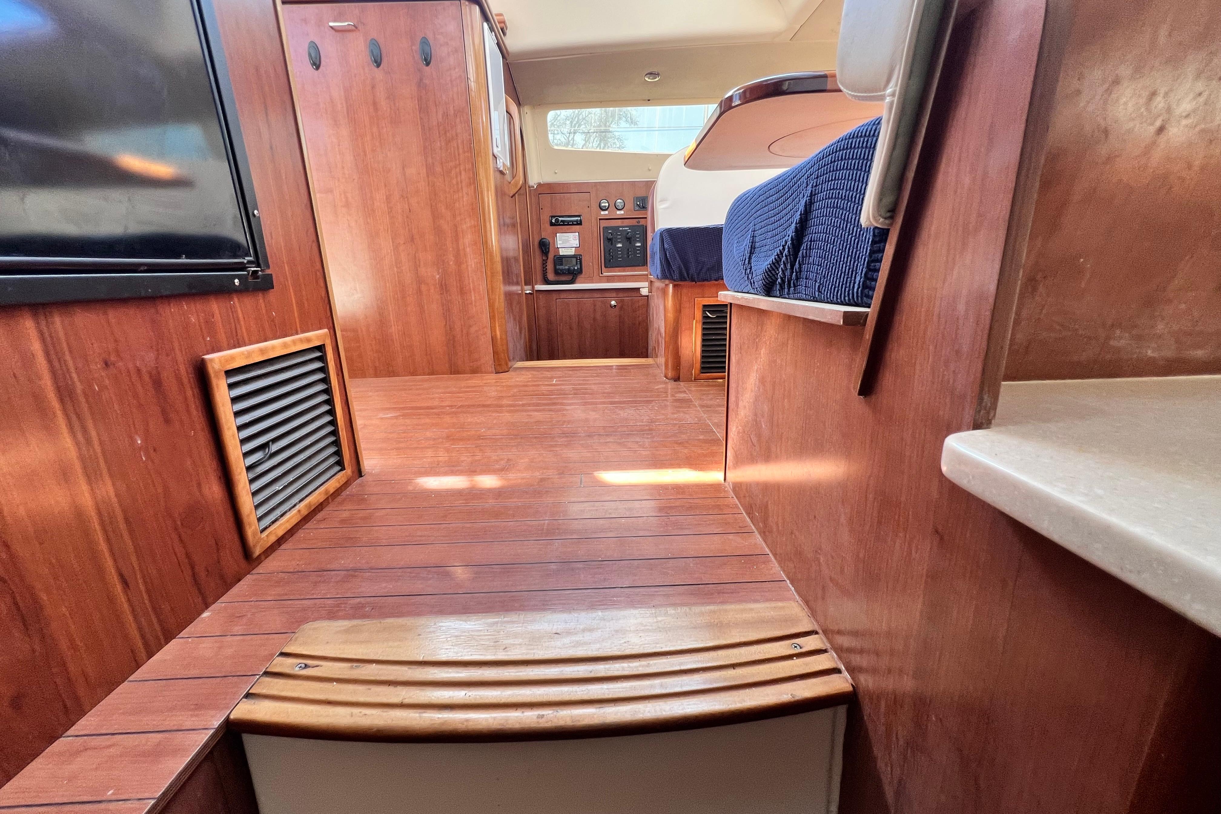 Interior of 2013 Gemini Legacy 35 boat with wooden flooring and cabinetry.
