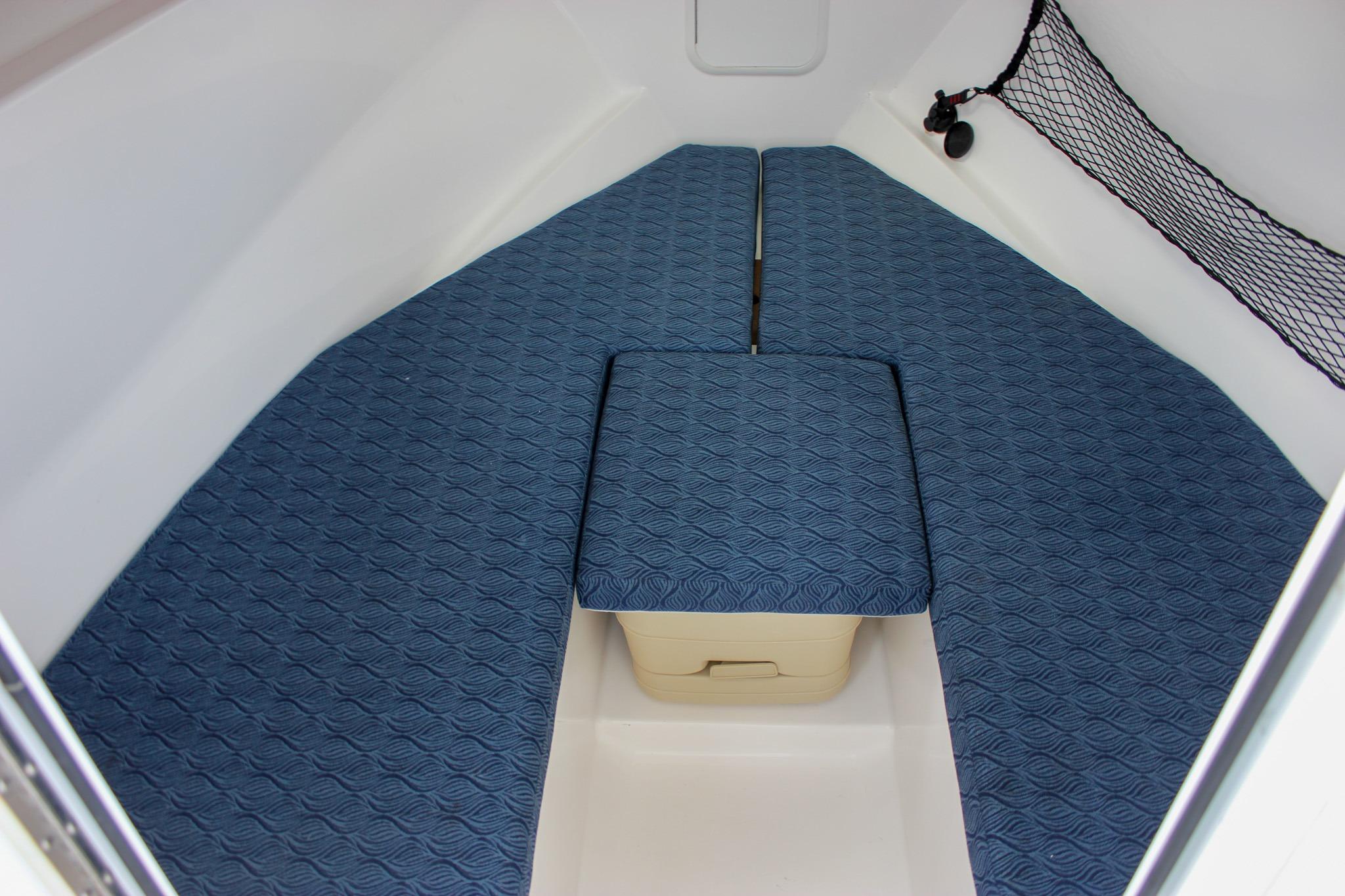 Interior of 2022 NorthCoast 235 Cabin with blue cushioned seating.