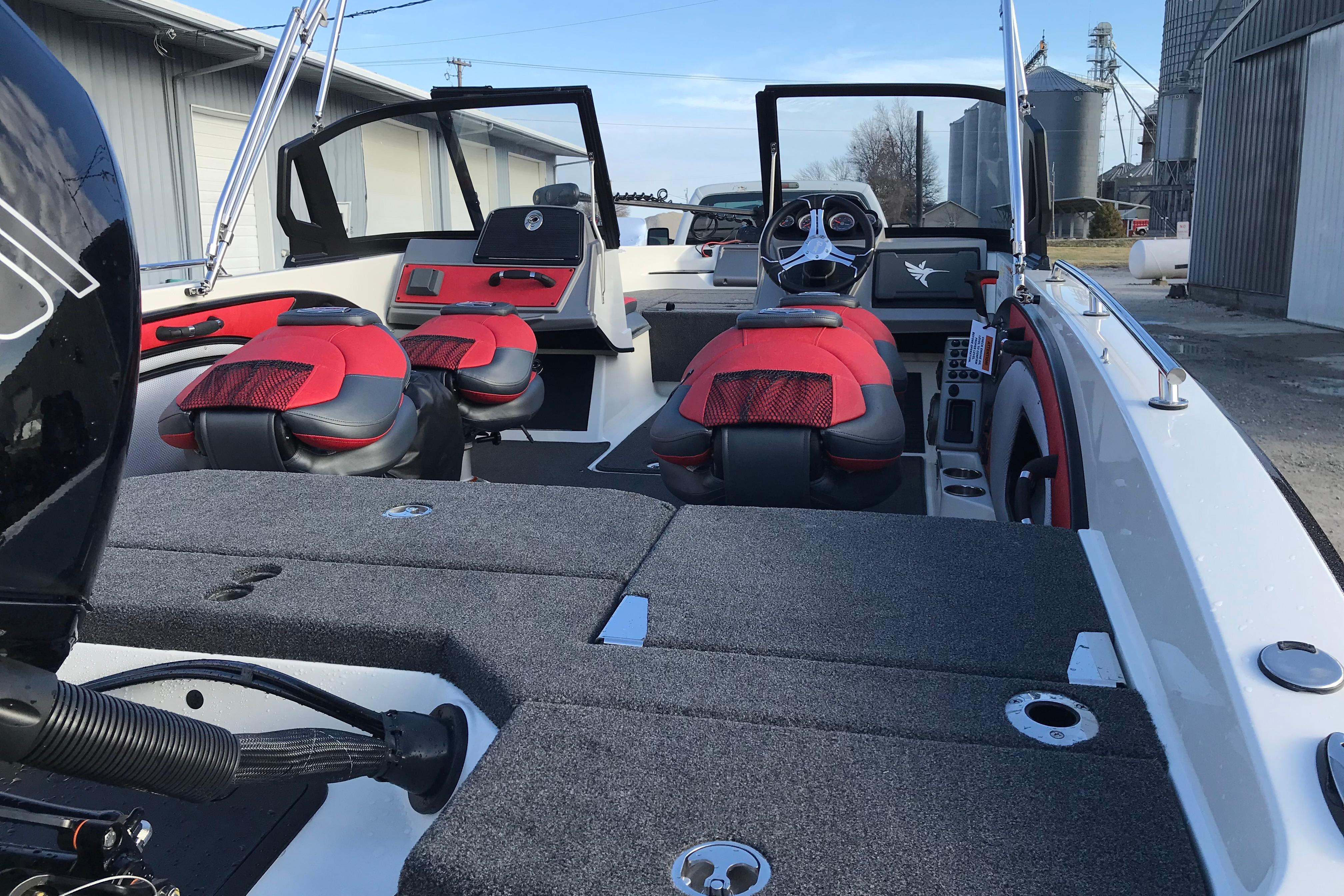 2026 Ranger 1850MS boat interior with red and black seats, steering wheel, and storage compartments.