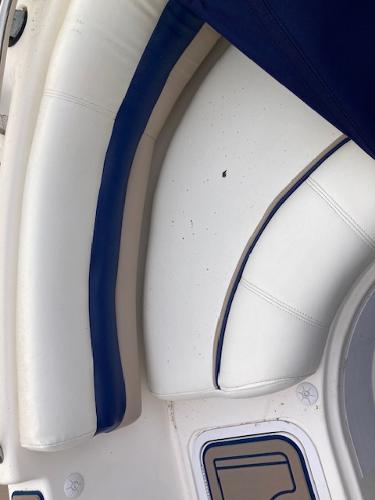 2006 Hurricane SunDeck 237 OB boat interior with white and blue seating.