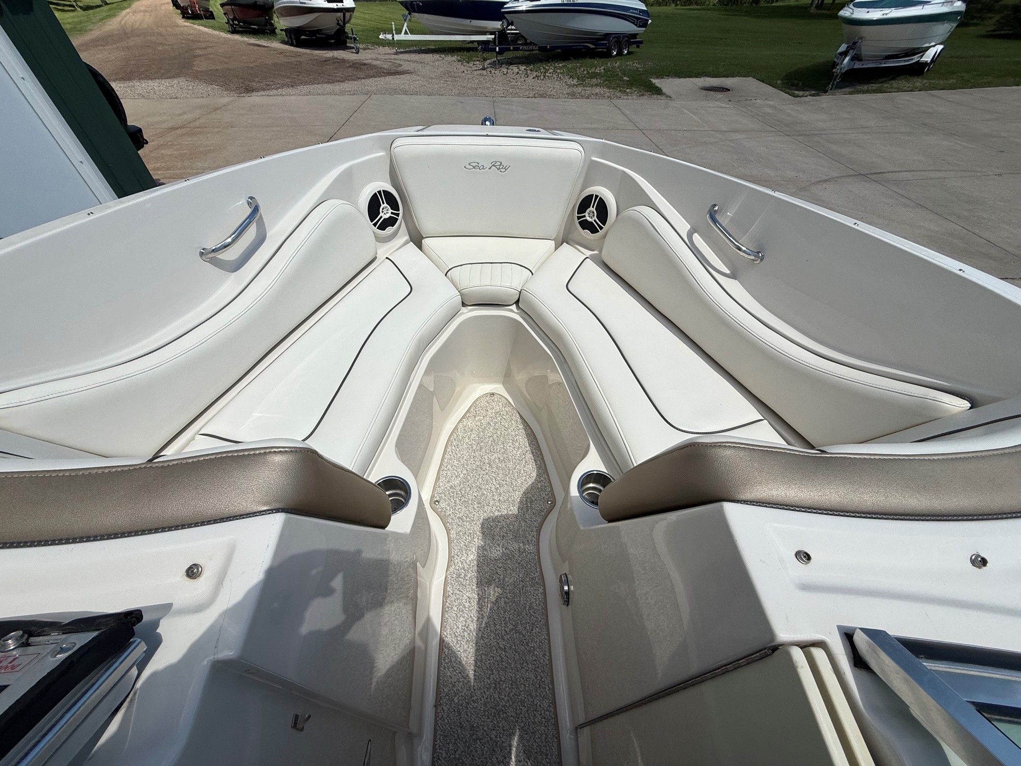 Interior of a 2007 Sea Ray 230 Select boat with white seating.