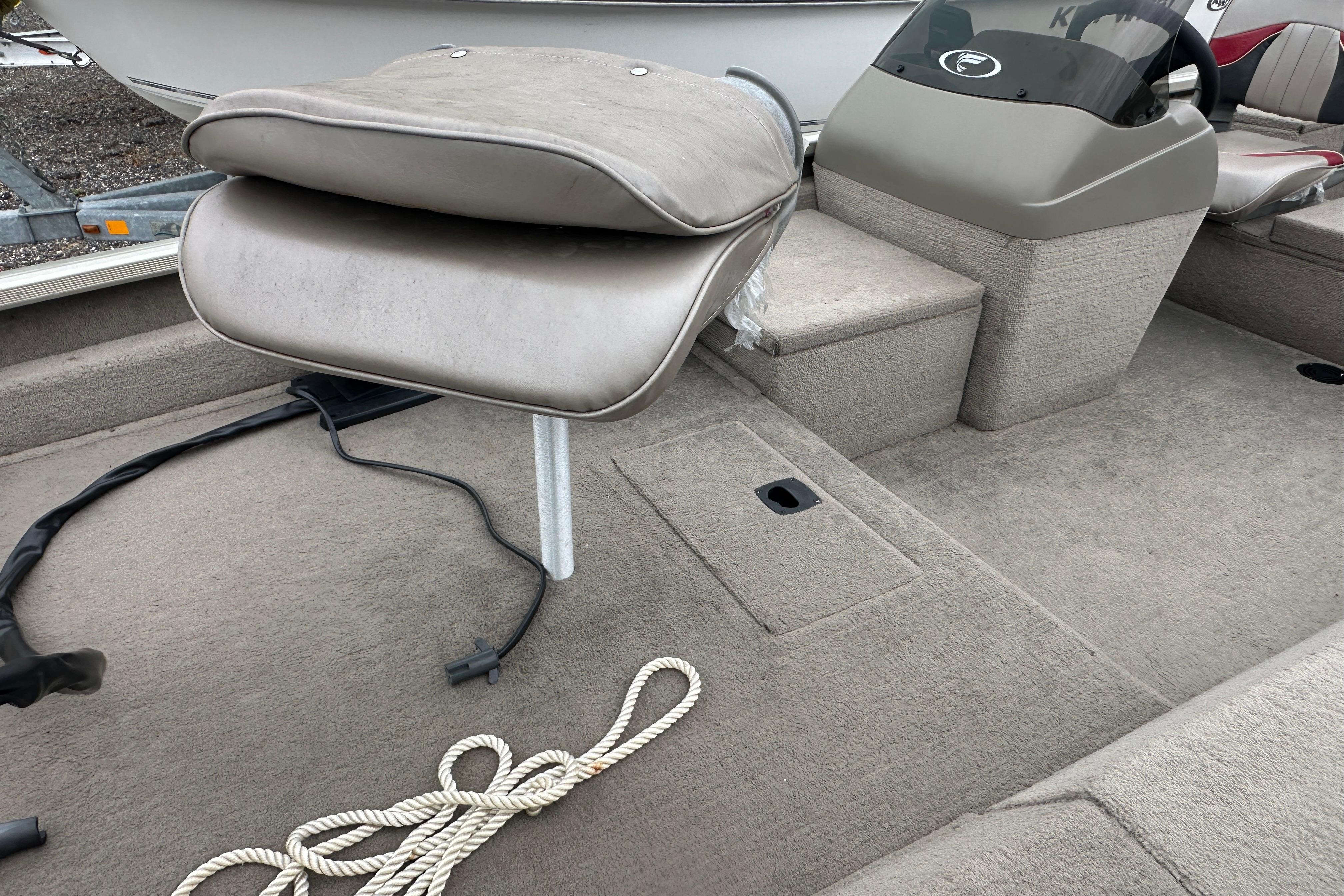 Interior of a 2002 Fisher 1710 boat with seating and rope.