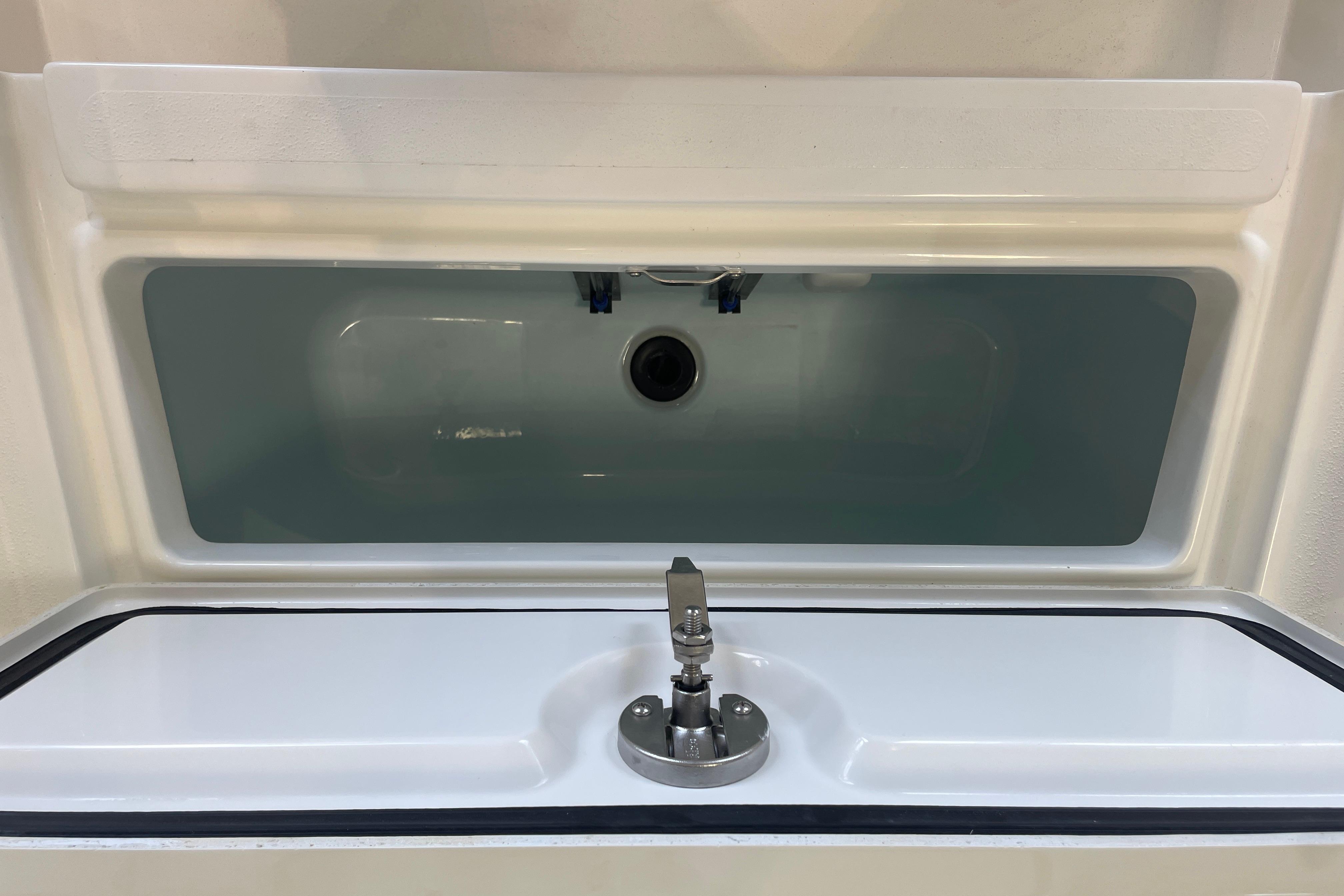Livewell on 2026 Mako 24 APEX boat, featuring a sleek design and modern faucet.