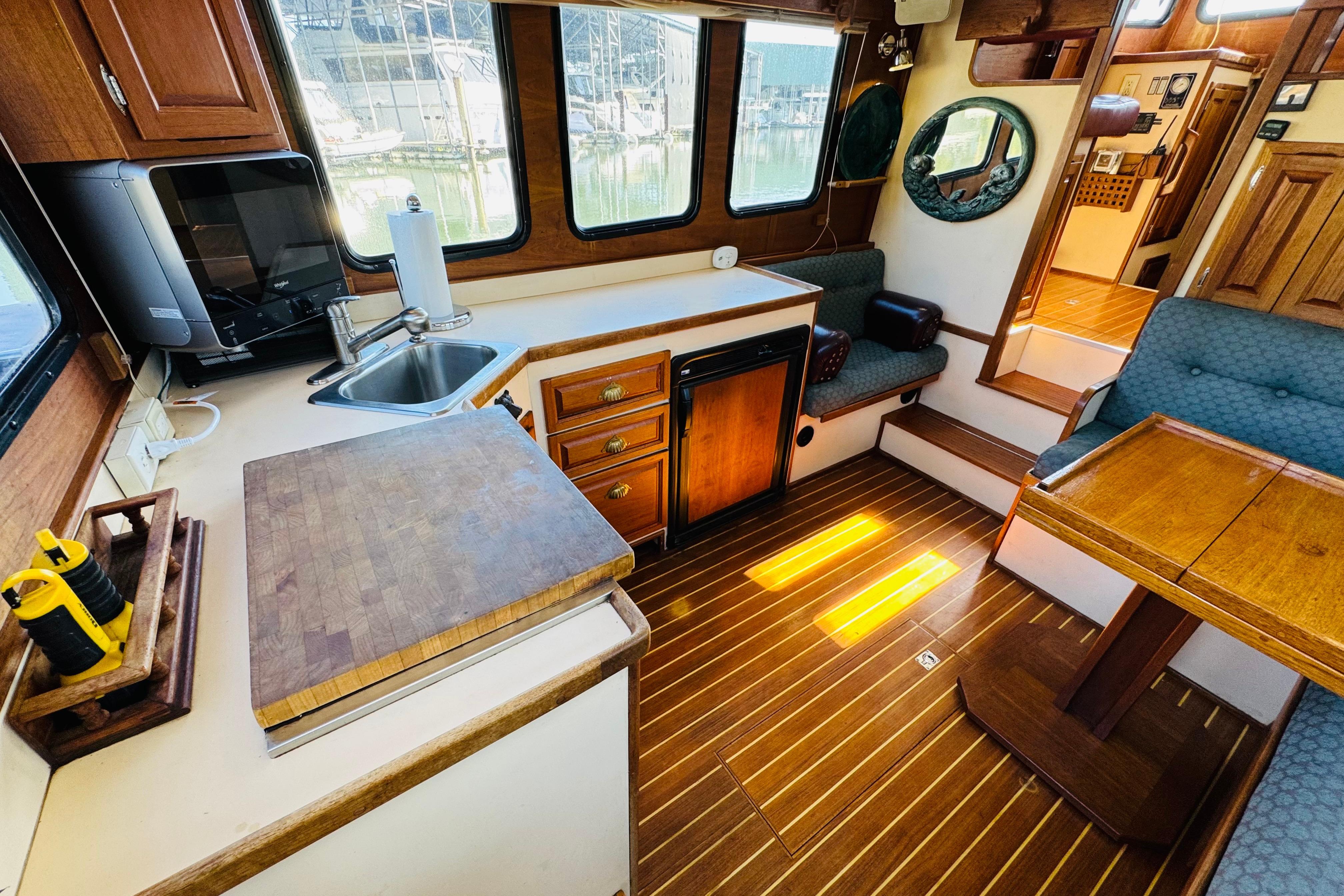 Interior of a 1996 Nordic Tug 32, featuring a cozy kitchen and dining area.