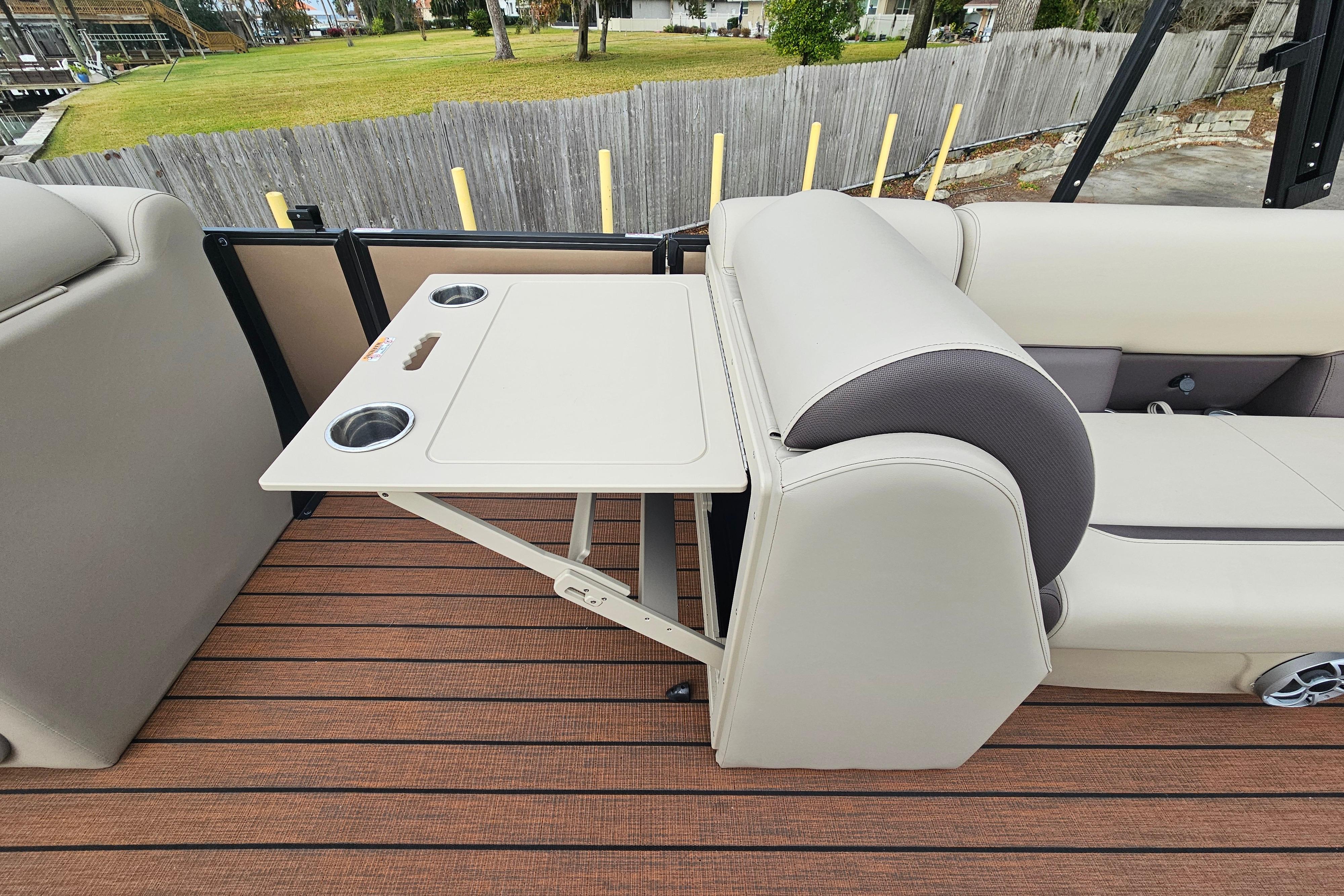2026 Bentley Pontoons Legacy 243 Cruise interior with foldable table and cup holders.