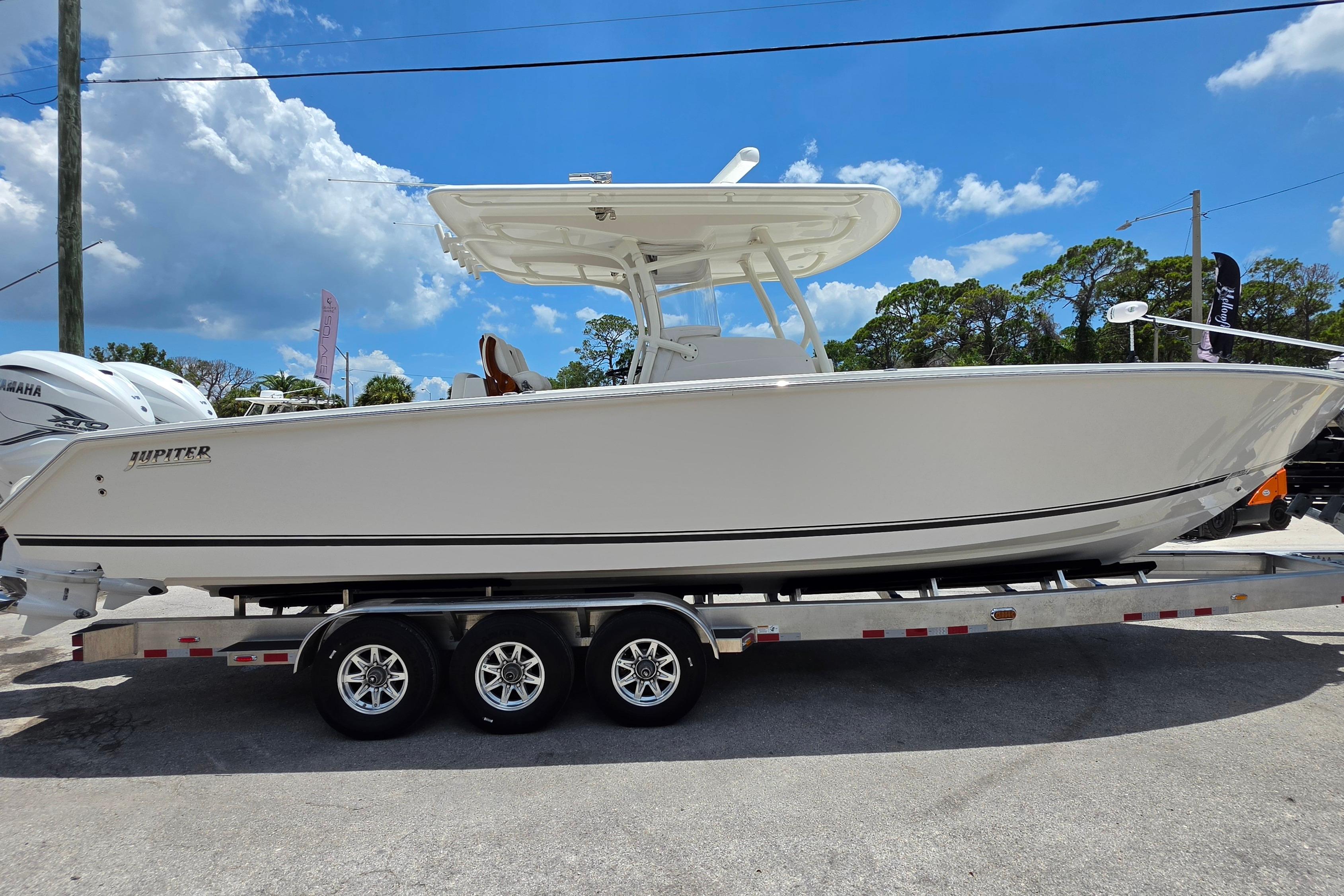 2020 Jupiter 34 HFS boat on trailer under clear blue sky.