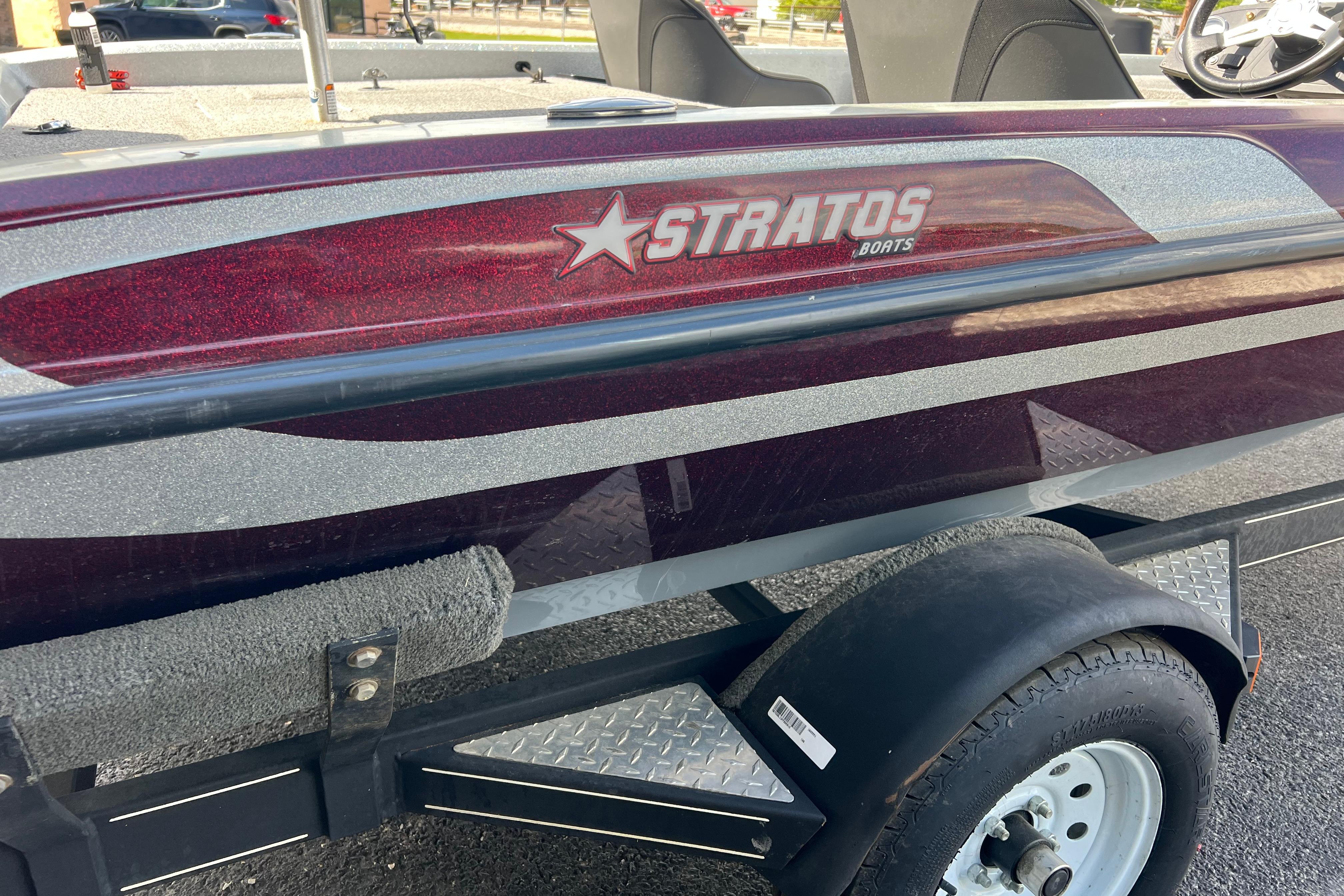 Stratos 186 VLO 2015 boat on trailer, featuring maroon and silver design.