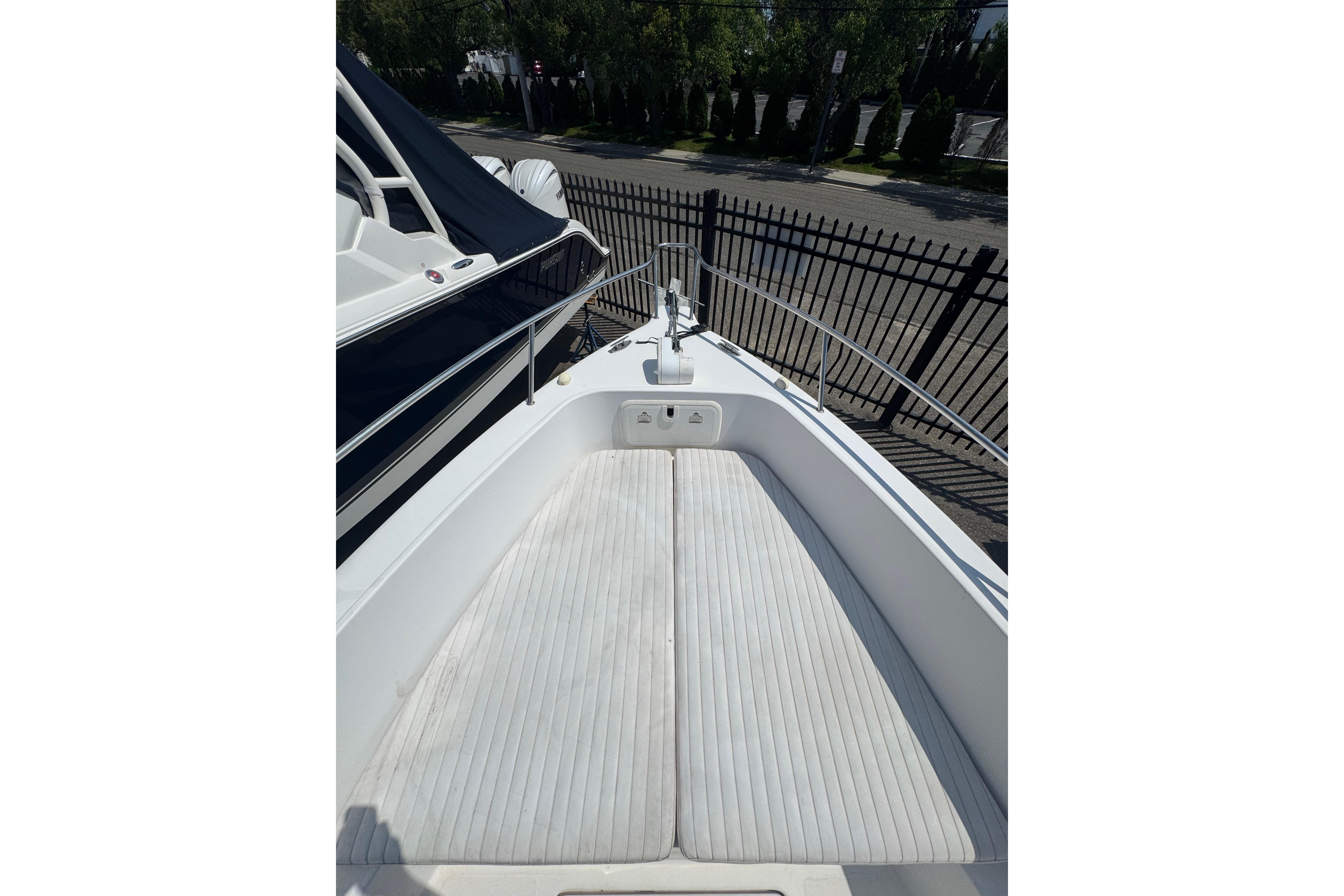 2002 Pro-Line 23 Sport boat bow with cushioned seating and railing.