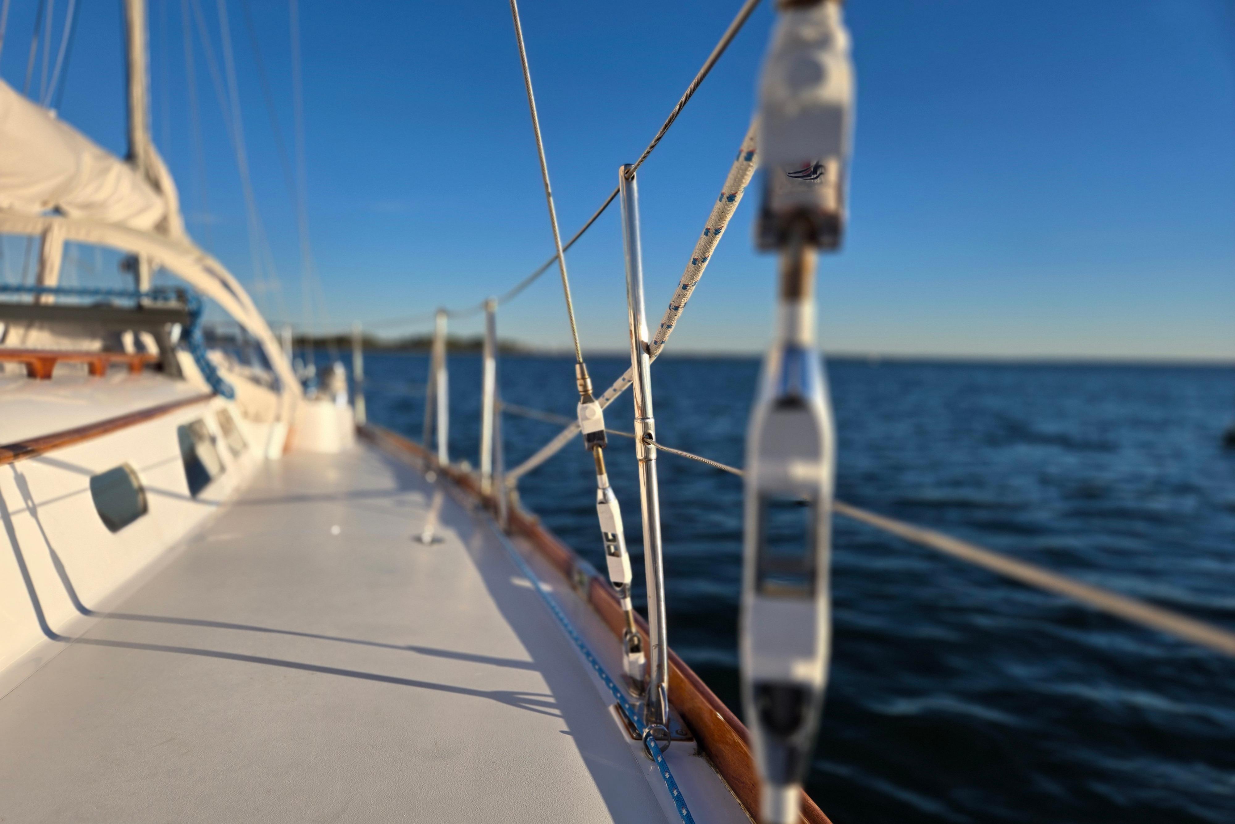 1970 Hinckley Bermuda 40 sailboat deck with ocean view and clear blue sky.
