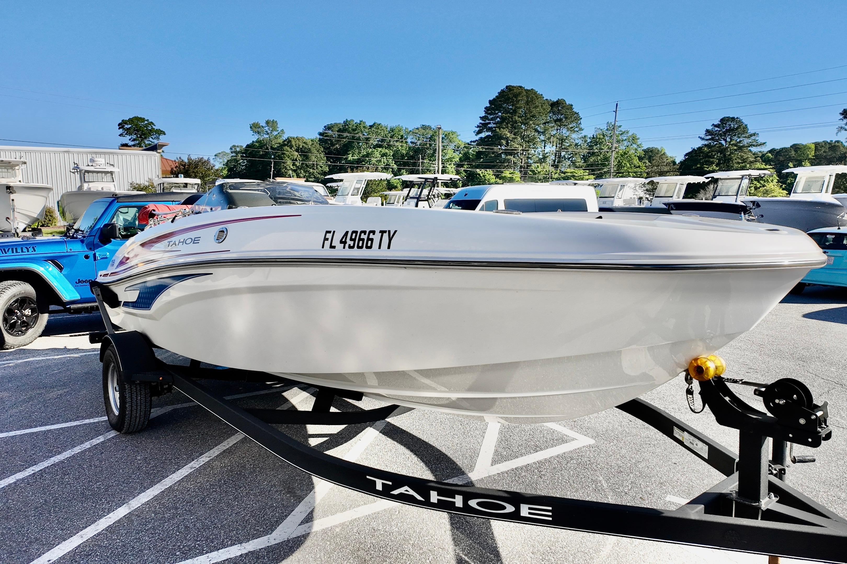 2024 Tahoe T18 boat on trailer in parking lot, sunny day.