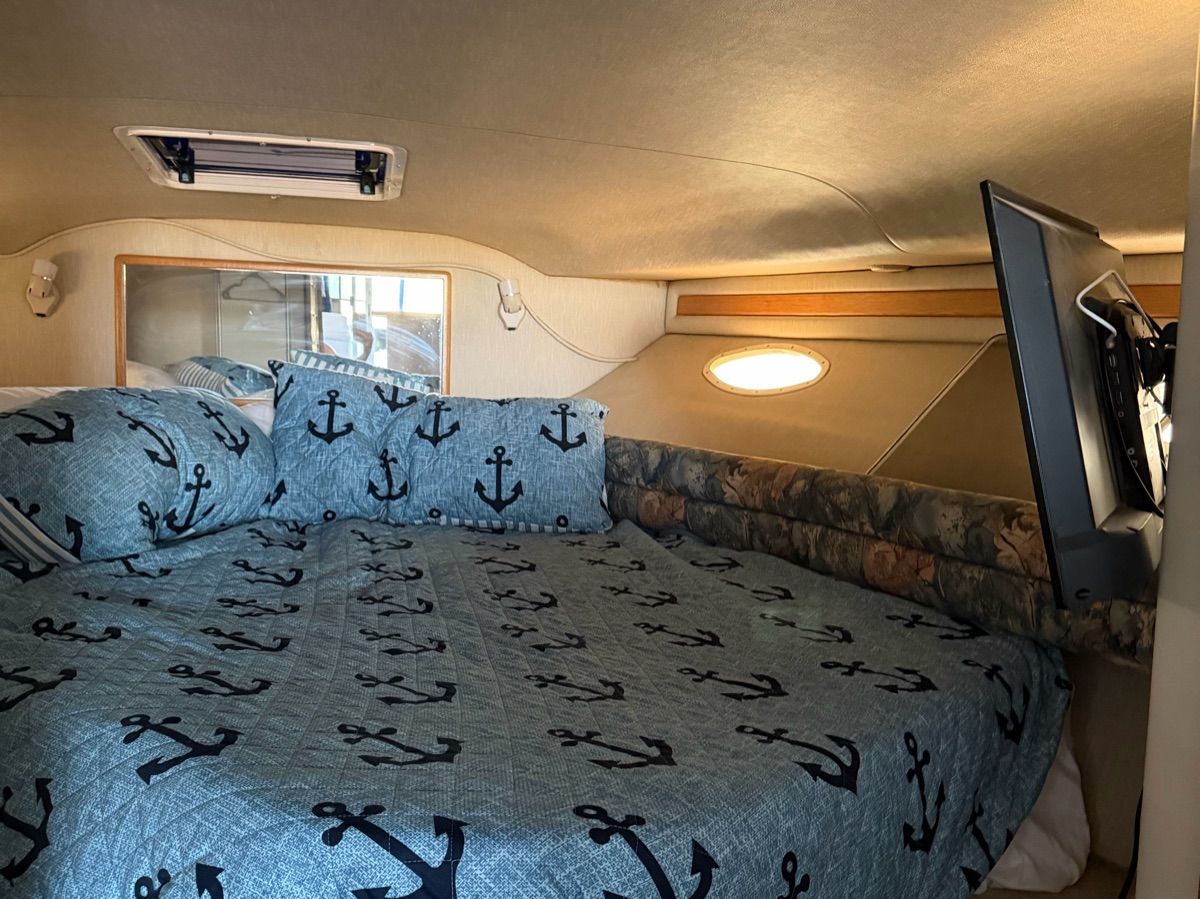 Interior of a 1996 Sea Ray 370 Sedan Bridge with anchor-themed bedding.