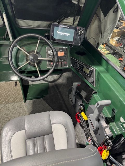 Interior of a 2023 Hewescraft 180 Sportsman boat with controls.