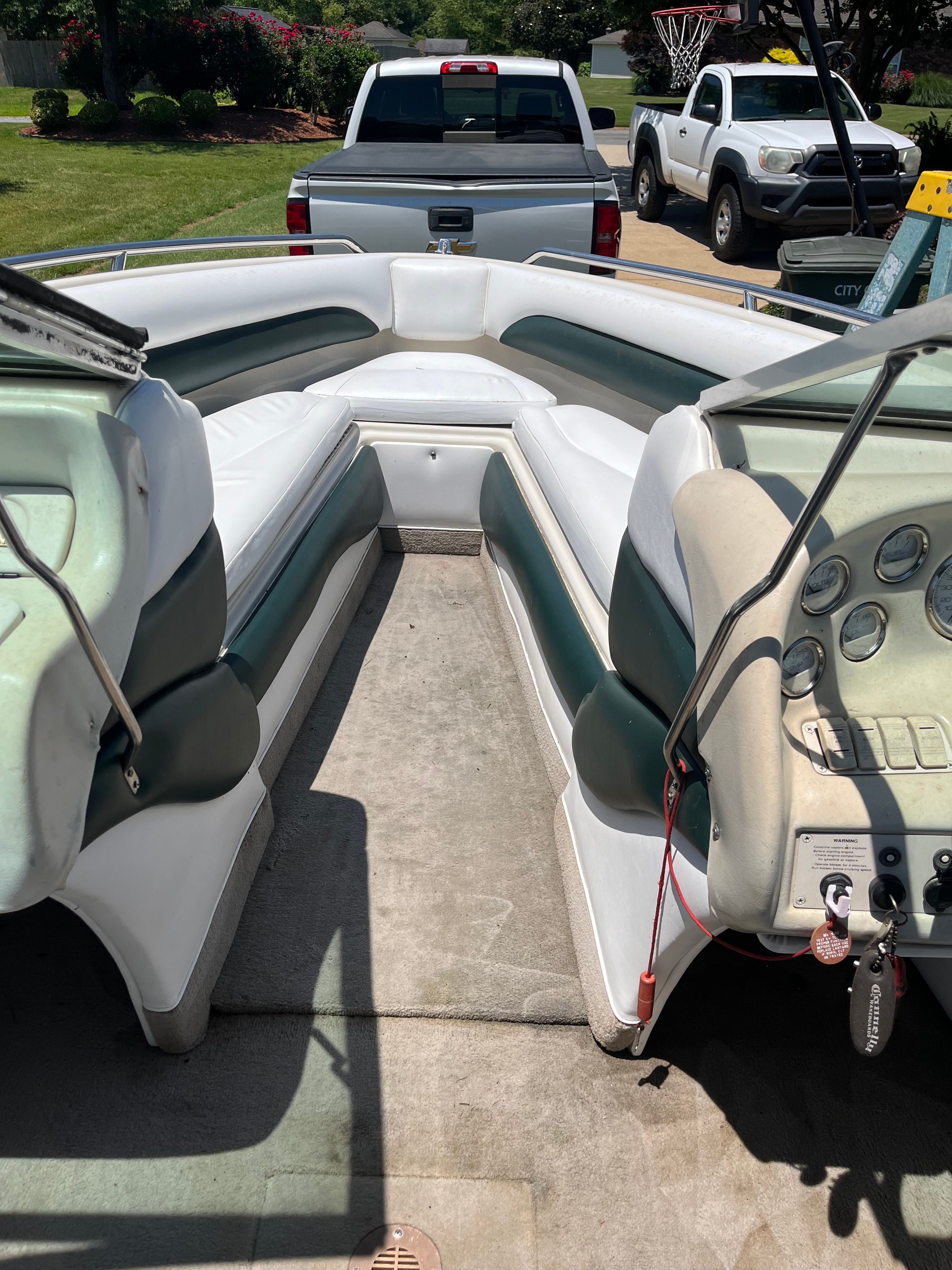Interior view of a 1996 Crownline 202 BR boat with white and green seating.