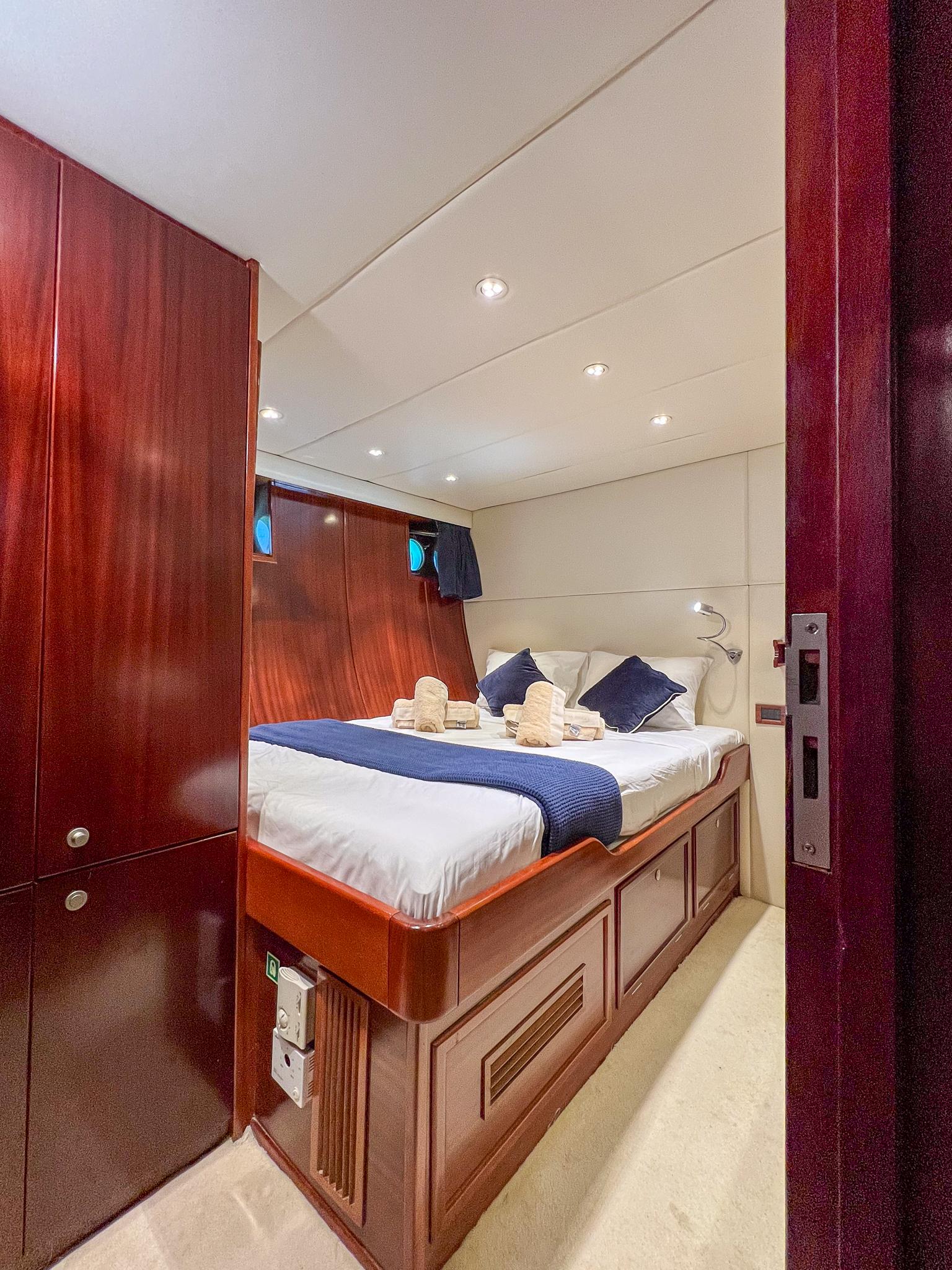 Luxurious cabin interior of 1969 Psarros Shipyard yacht with elegant wood finish.
