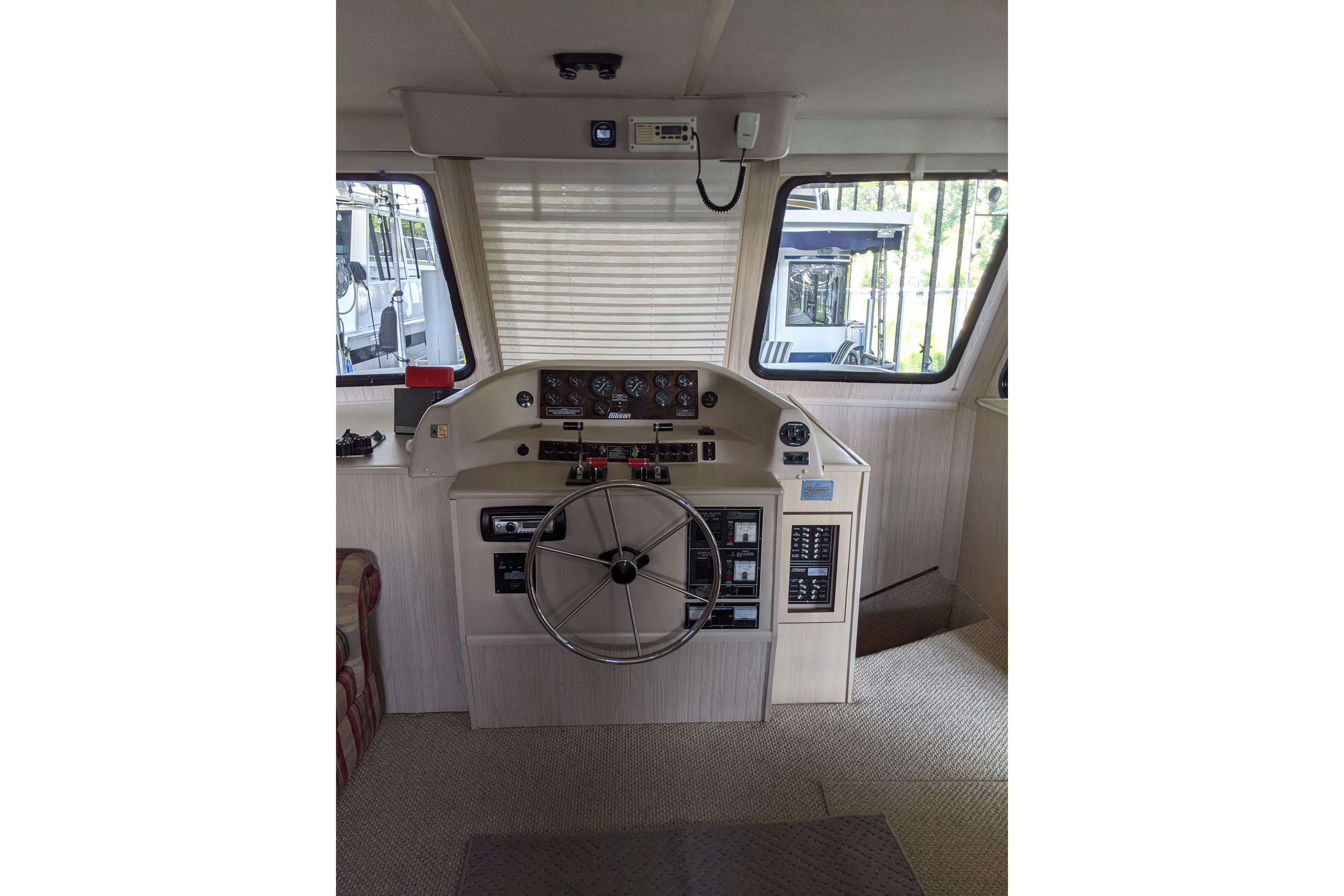 Helm of 2001 Gibson 50 Cabin Yacht with steering wheel and control panels.