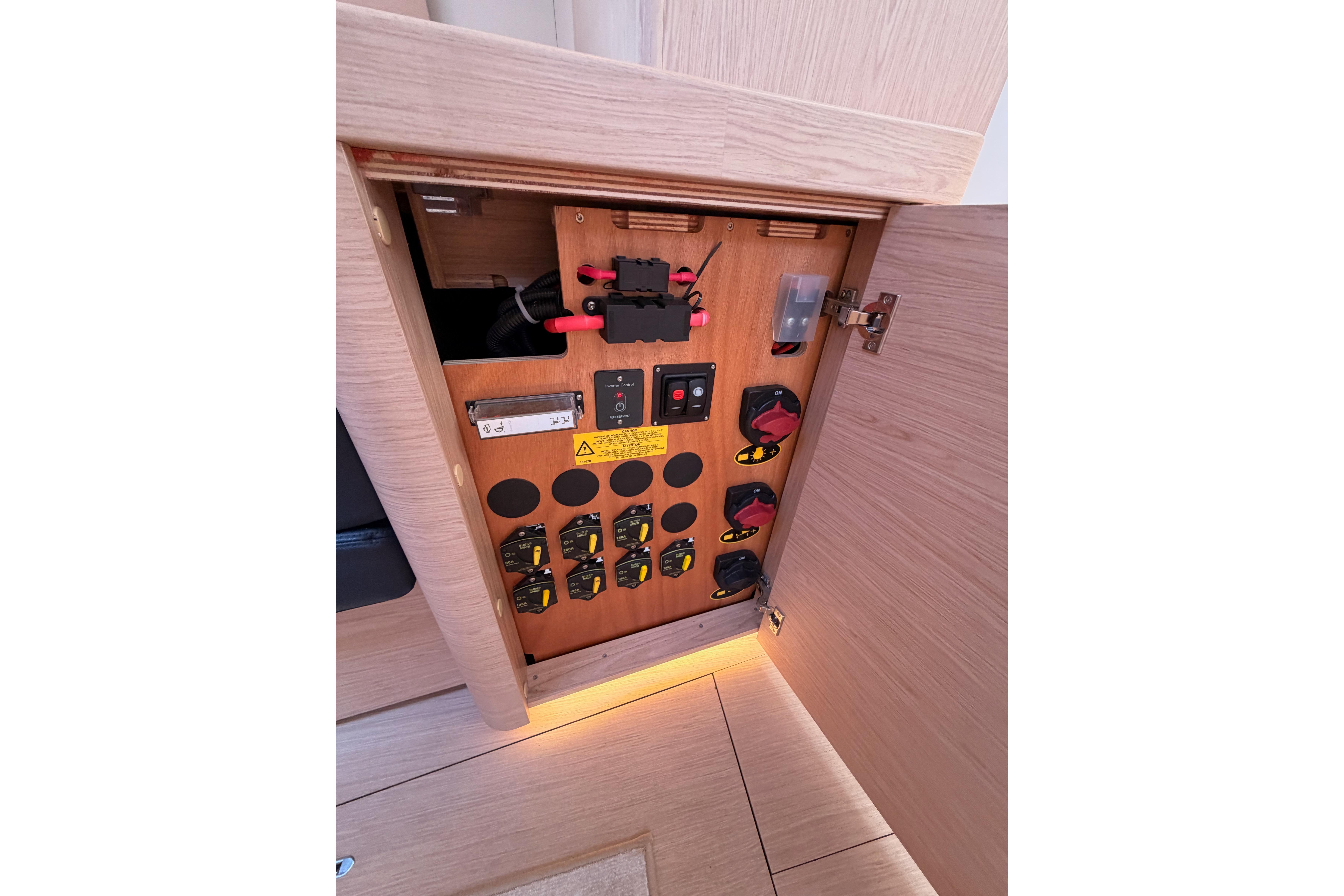 Electrical panel inside 2022 Beneteau Oceanis Yacht 54, showcasing switches and wiring.