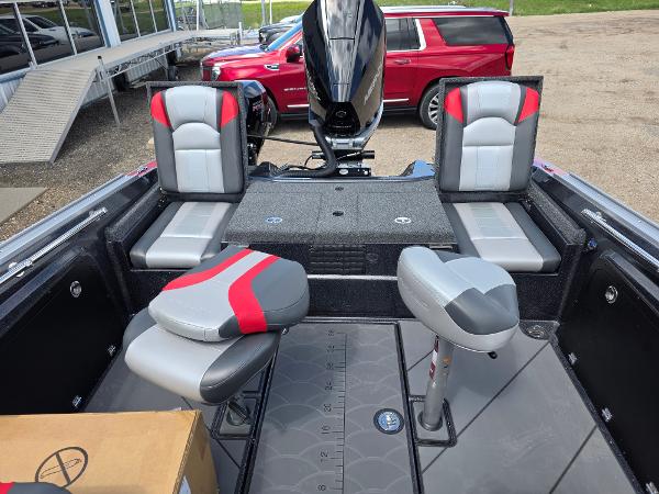 2025 Nitro ZV-20 SPORT boat interior with red and gray seating, parked near a red SUV.