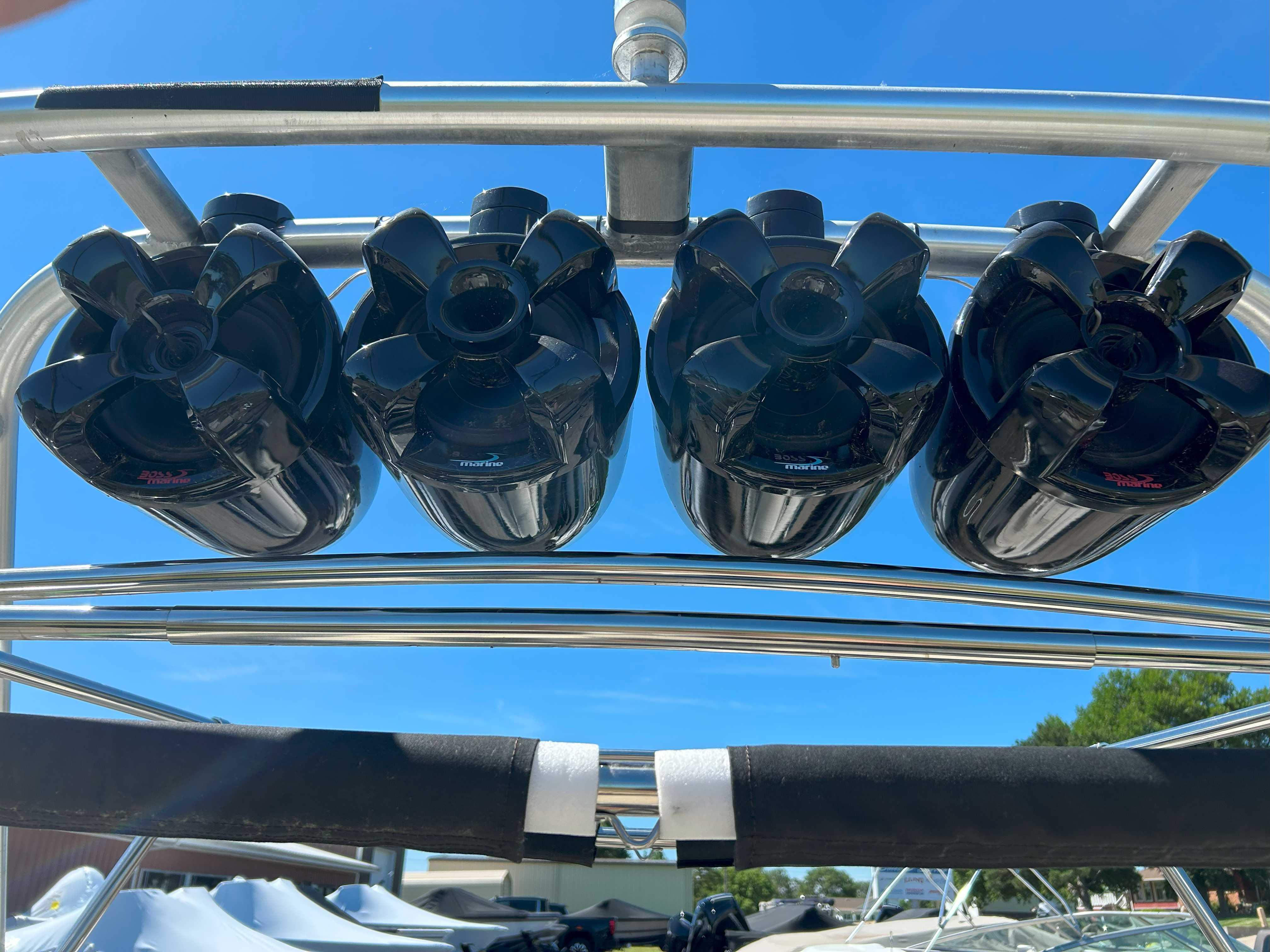 Four black speakers mounted on a 2002 MasterCraft XStar boat tower.