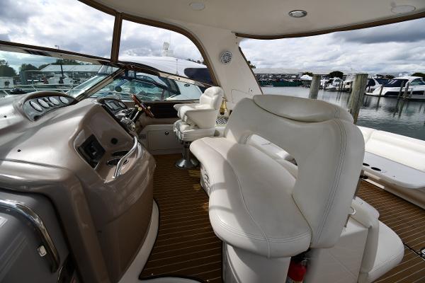 2003 Sea Ray 460 Sundancer yacht interior with plush seating and modern dashboard.