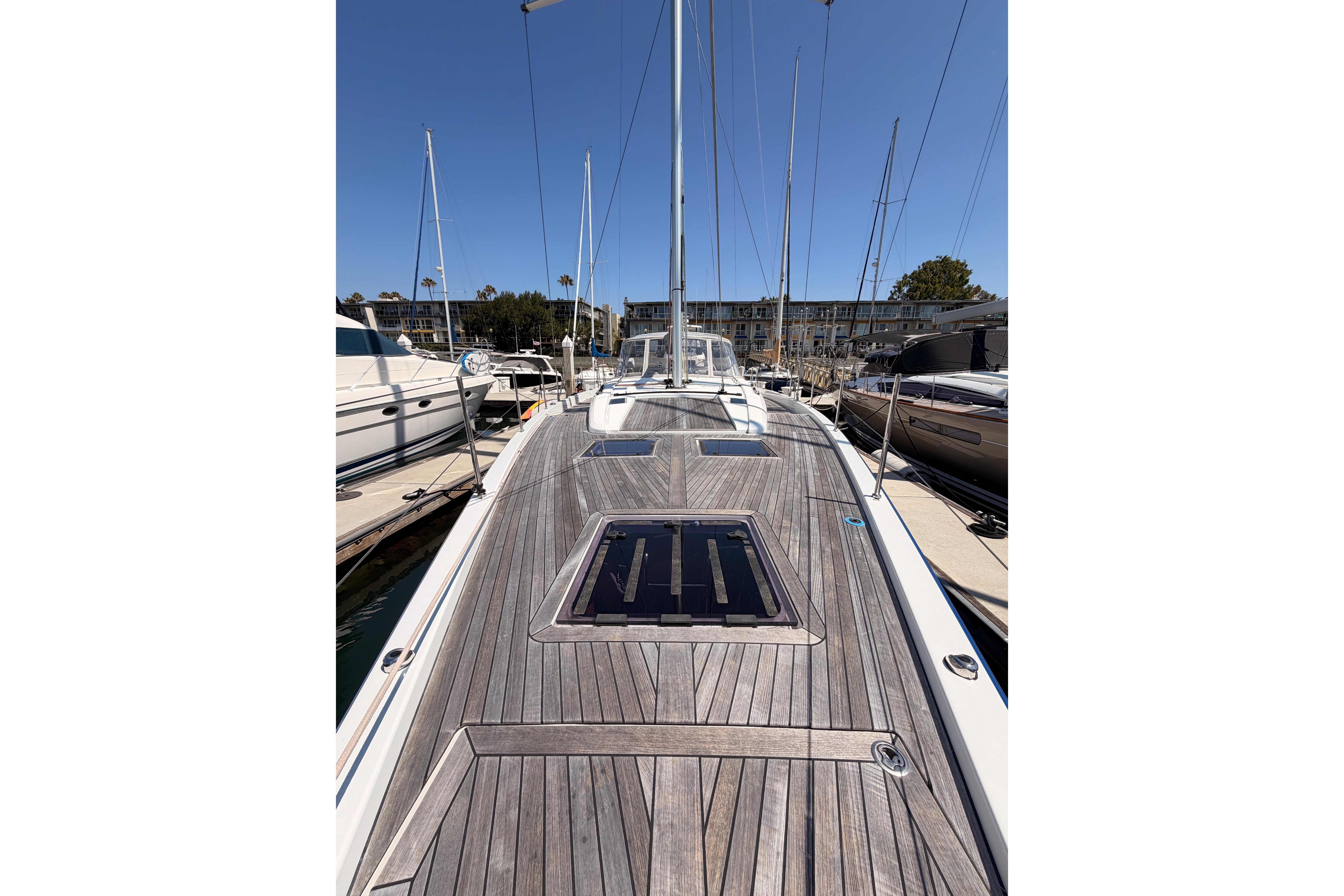 2022 Beneteau Oceanis Yacht 54 docked, showcasing sleek wooden deck design.