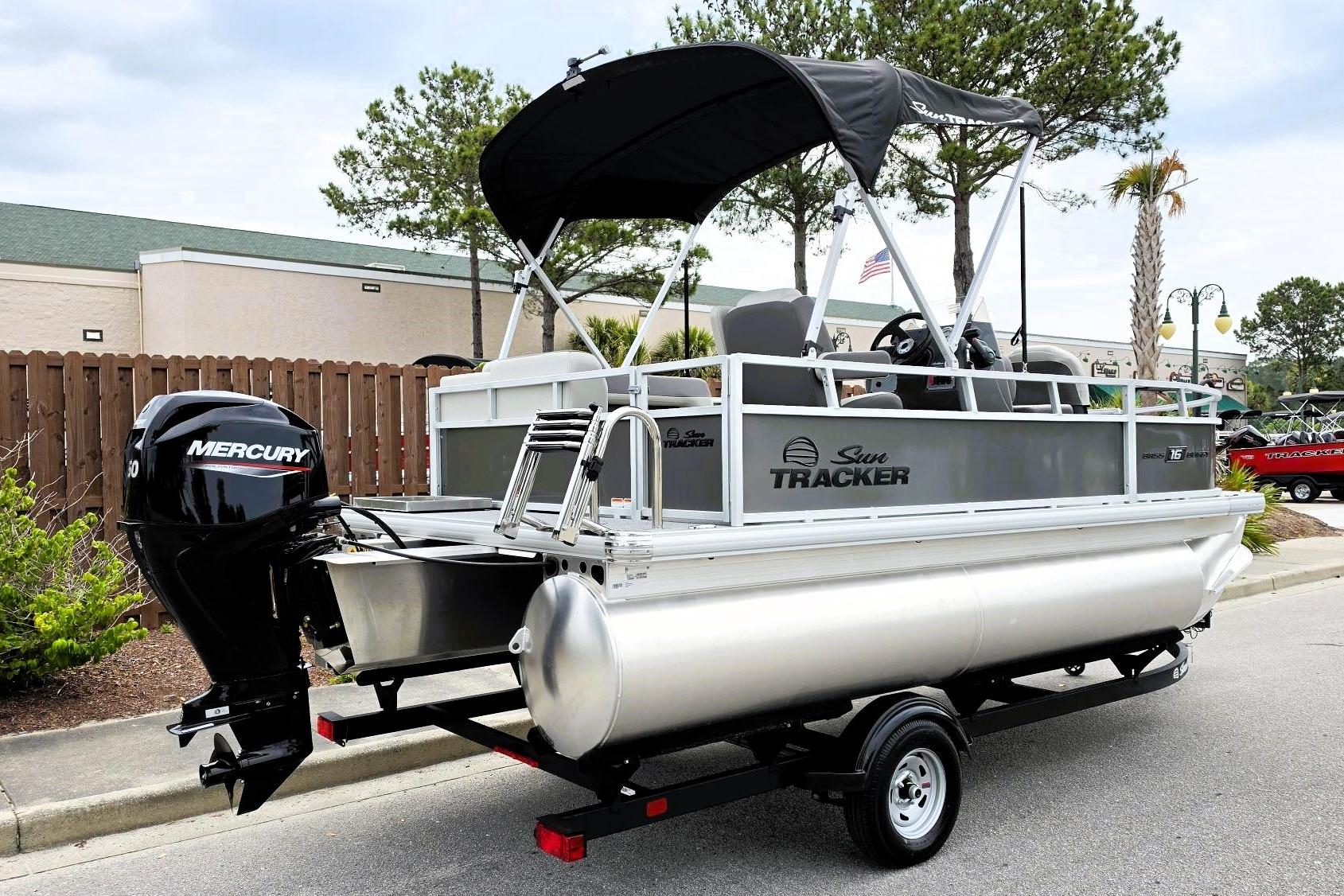 2026 Sun Tracker Bass Buggy 16 XL Select pontoon boat with Mercury engine on trailer.