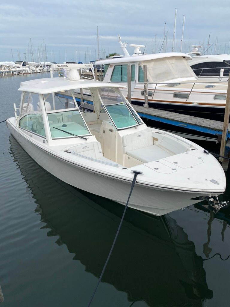 2023 Cobia 330 boat docked in marina.