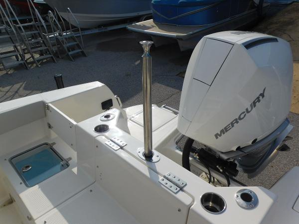 2025 Sailfish 232 CC boat with Mercury engine, featuring rod holders and cup holders.
