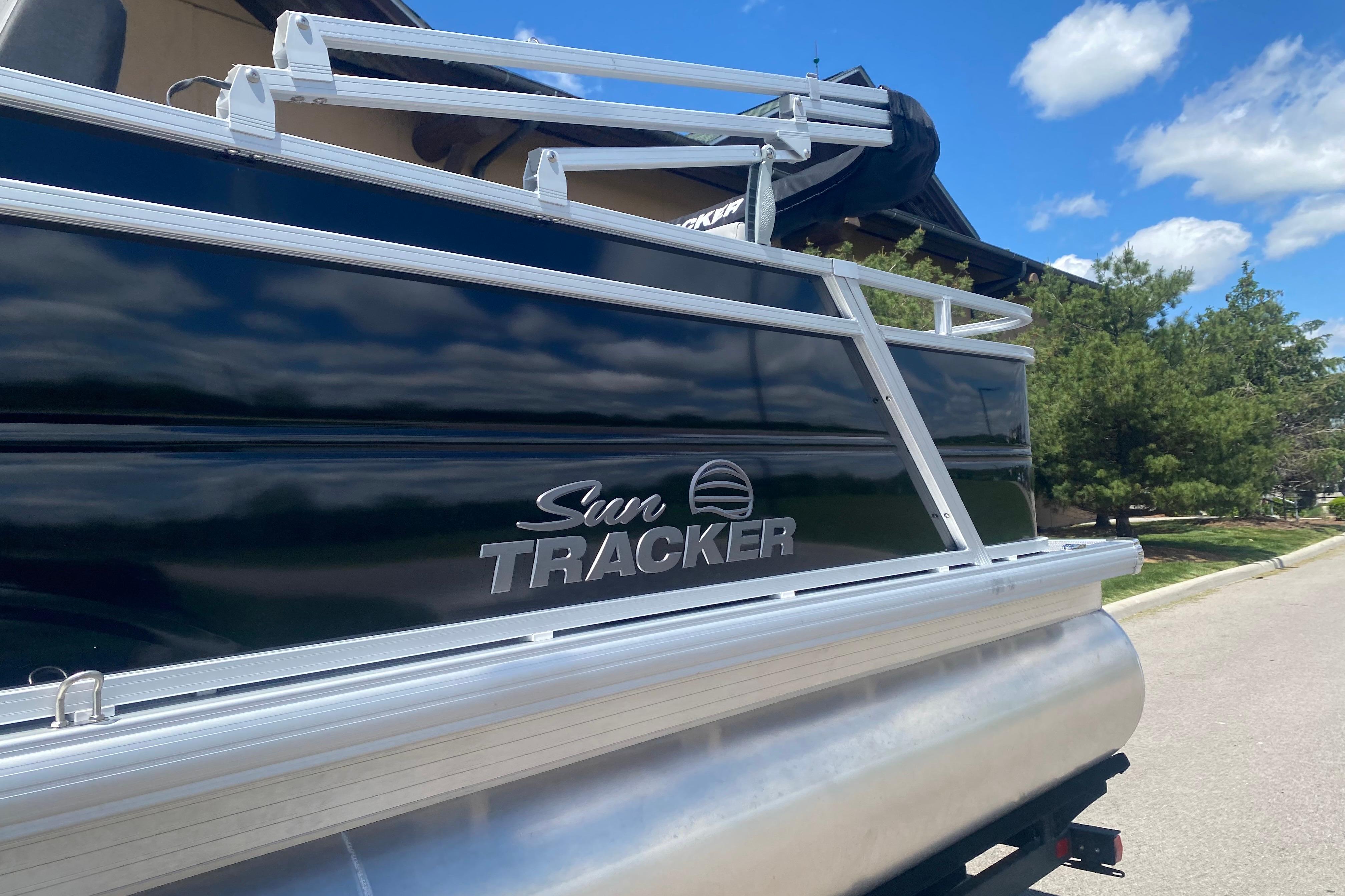 2026 Sun Tracker Party Barge 22 RF DLX pontoon boat under a clear blue sky.