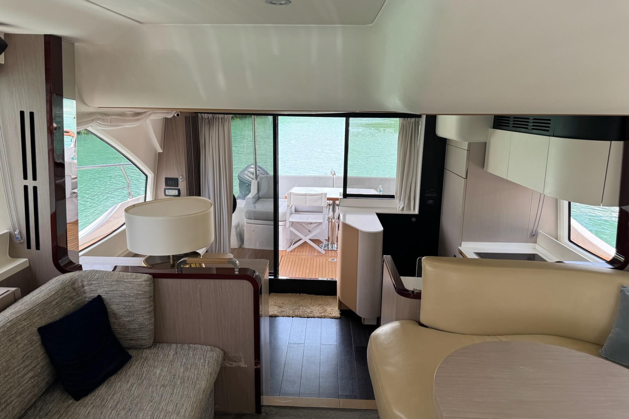 Luxurious interior of a 2021 Azimut 55 yacht with elegant furnishings and scenic water view.