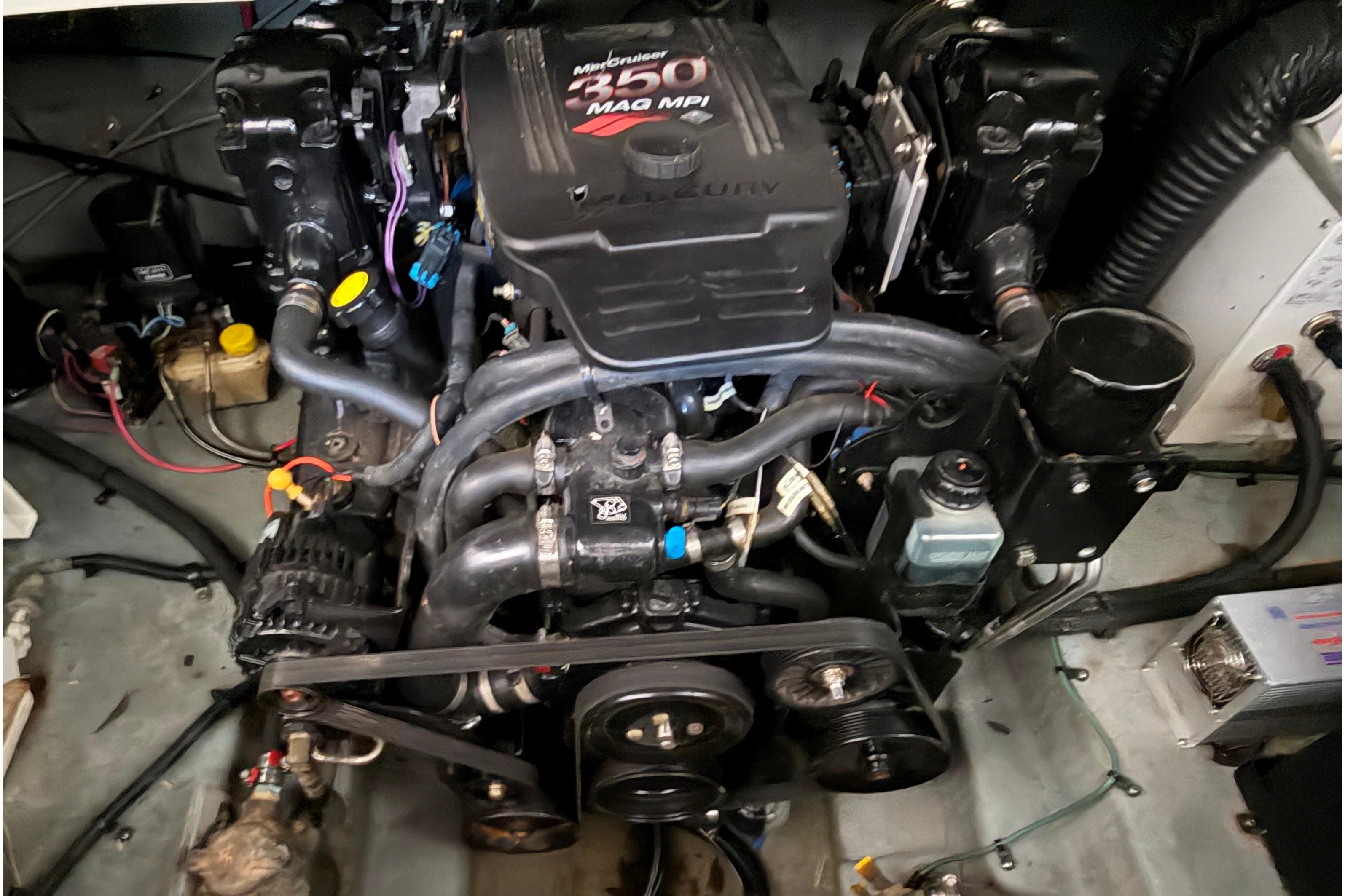 Engine of a 2004 Sea Ray Sundancer 260 boat, showcasing mechanical components.