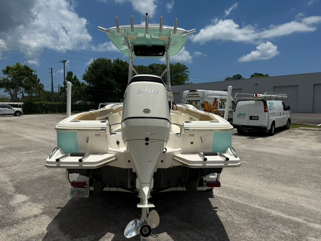 Rear view of a 2021 Pioneer 22 SF boat in a parking lot.