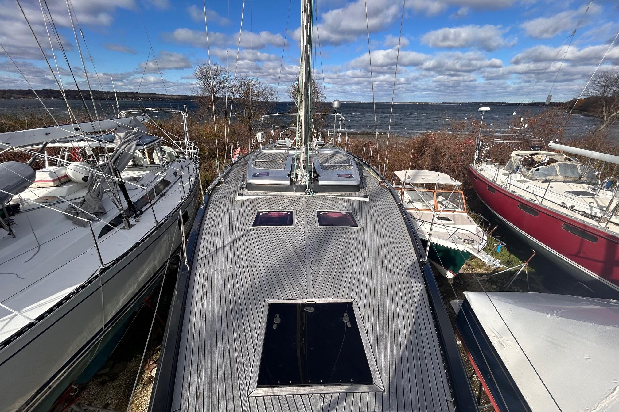 Hanse 545 sailboat from 2010 docked with scenic ocean view and cloudy sky.