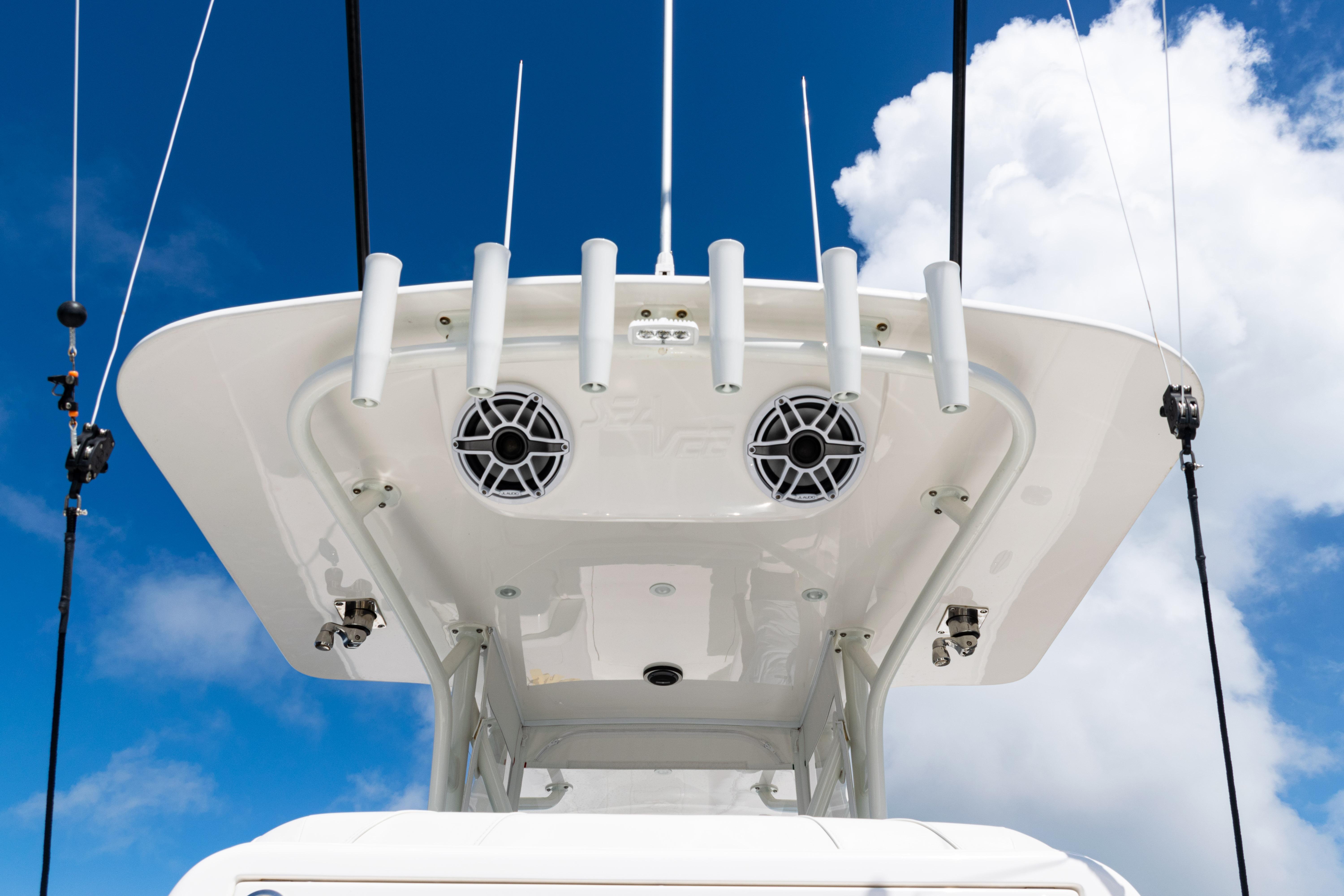 2023 SeaVee 340Z boat top view with rod holders and speakers against blue sky.