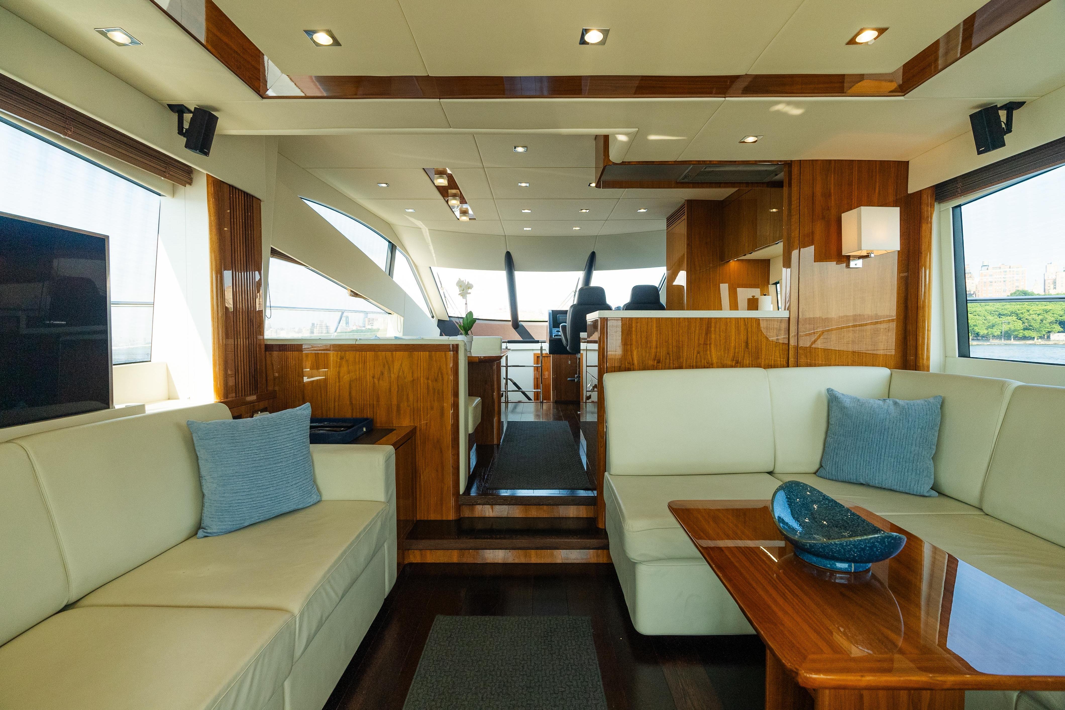Luxurious interior of 2016 Sunseeker Manhattan 65 yacht with elegant wood finishes.