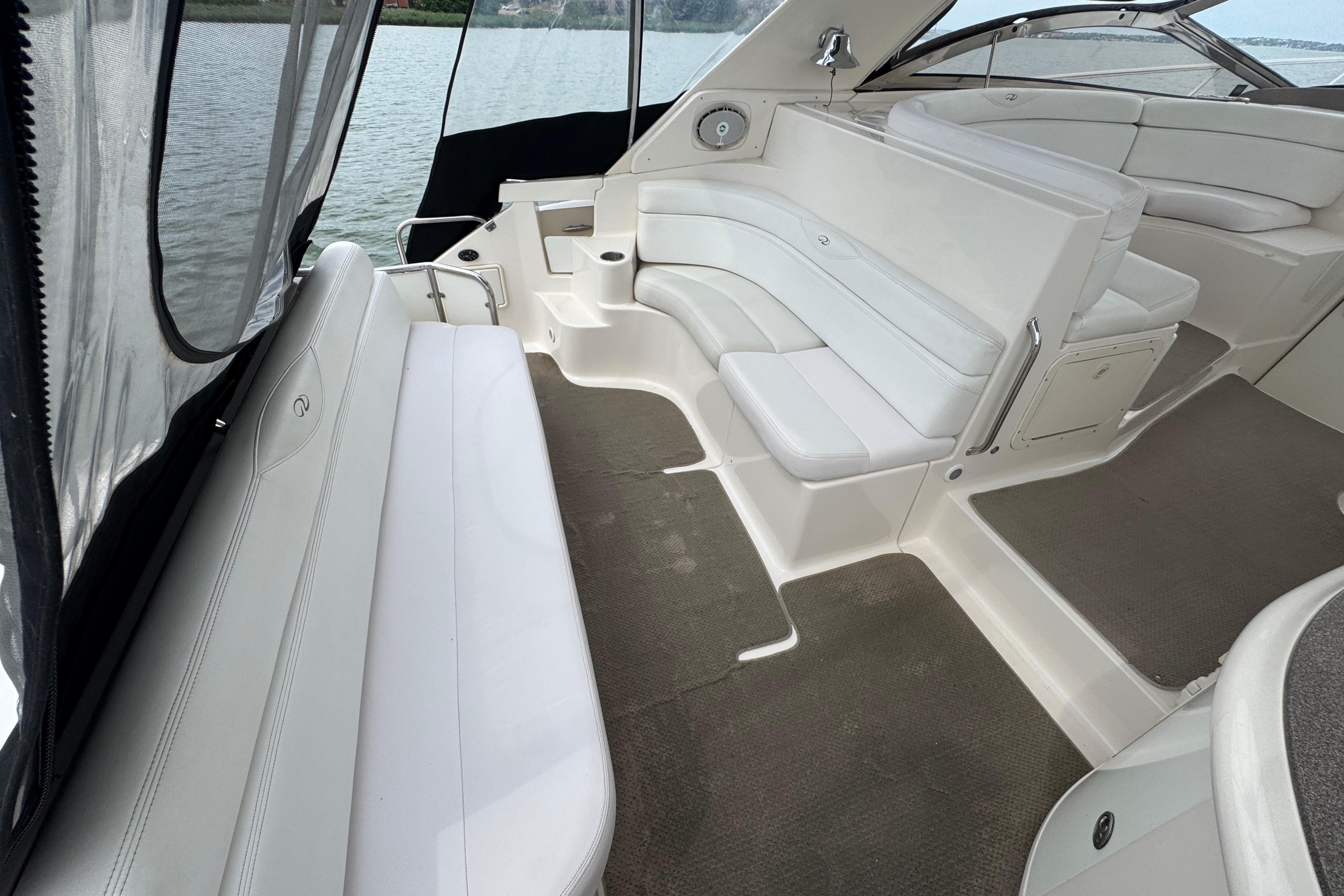 2005 Regal Commodore 4260 yacht interior with white seating and spacious layout.