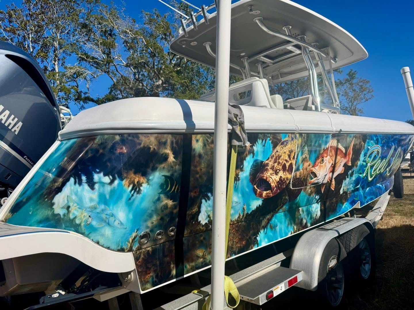 2021 Intrepid 327 Nomad boat with vibrant underwater design.