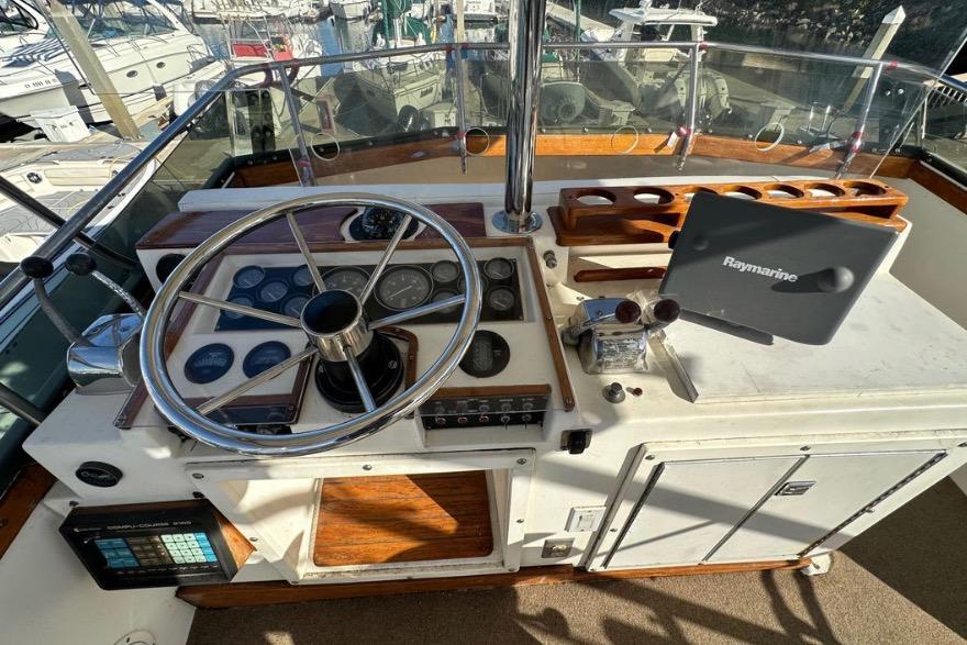 Cockpit of 1985 Egg Harbor 33 Sedan with steering wheel and Raymarine navigation system.