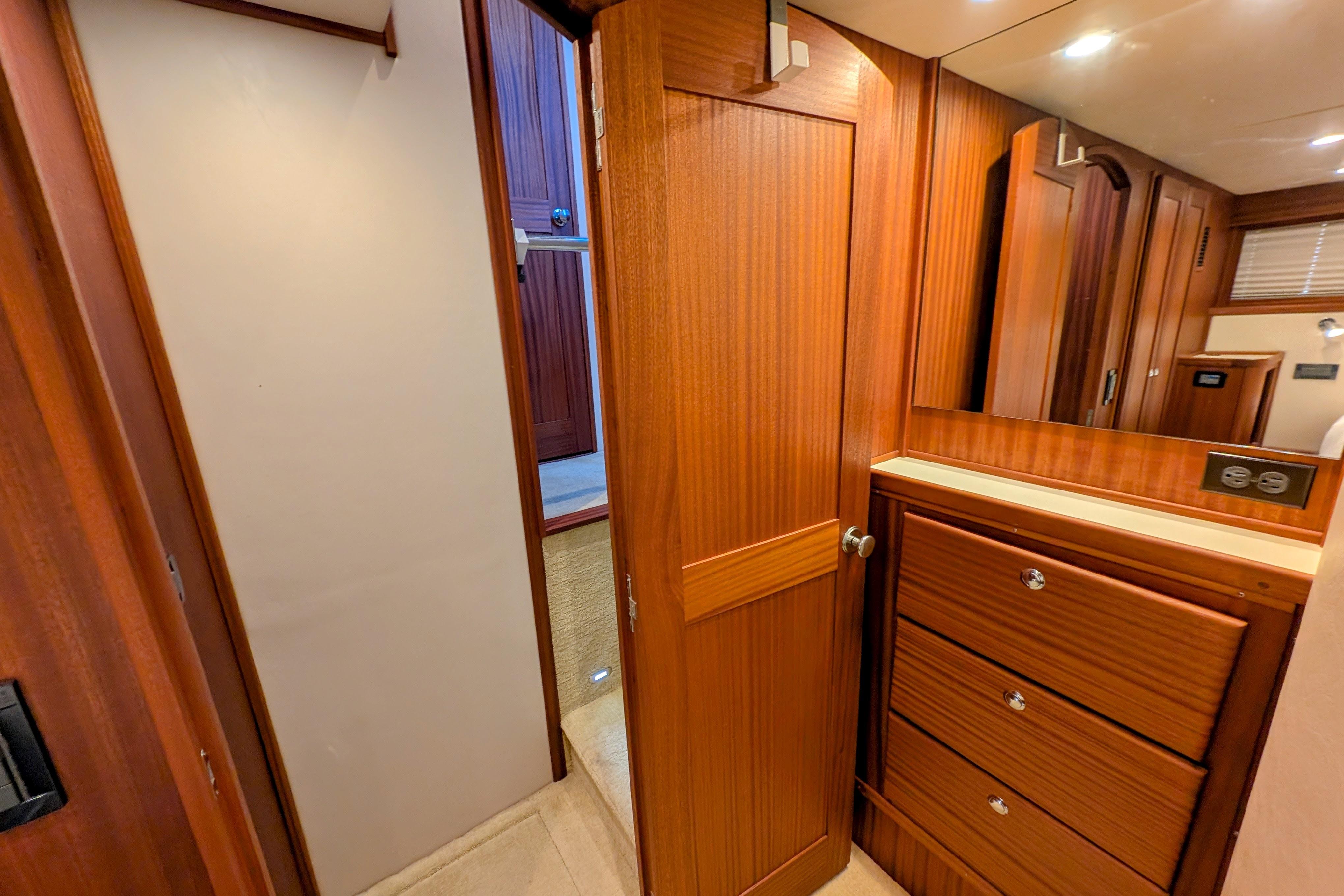 Interior of 2015 American Tug 435 with wooden cabinetry and drawers.