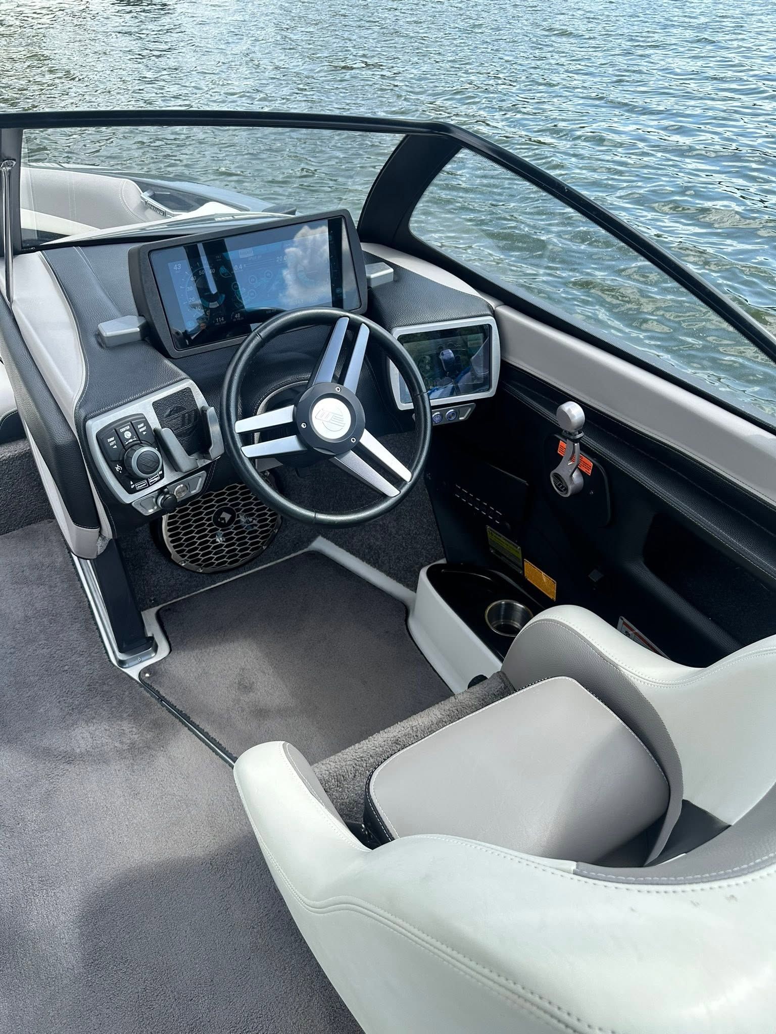 The cockpit of a 2015 Malibu Wakesetter 23 LSV with modern steering and electronics.