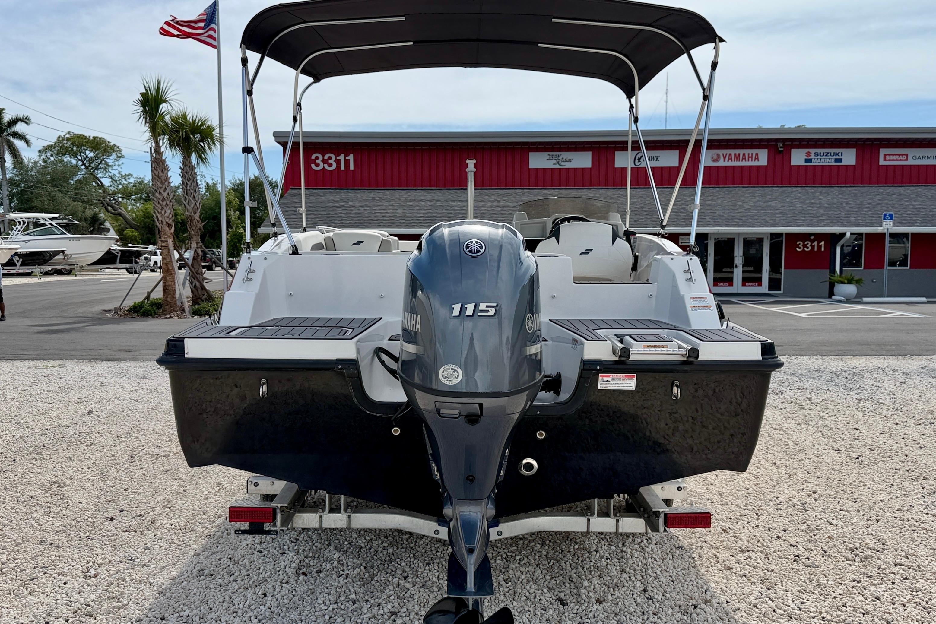 2021 Starcraft SVX 191 OB boat with Yamaha 115 engine, parked outside dealership.