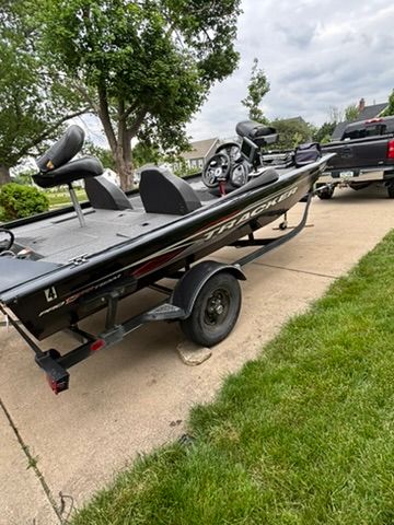 A 2020 Bass Tracker Pro 175TXW on a trailer in a driveway.