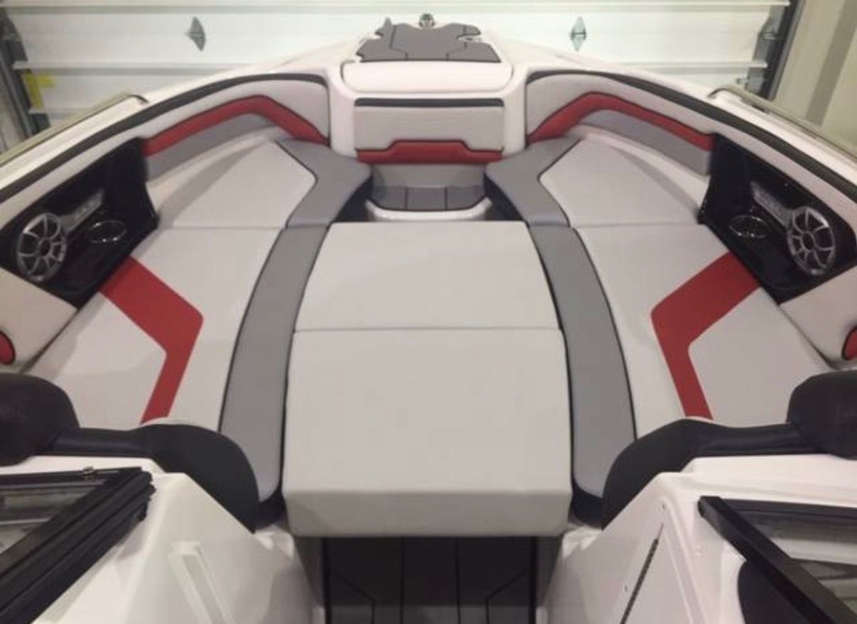 Interior of 2020 Yamaha AR242X boat with gray and red upholstery.