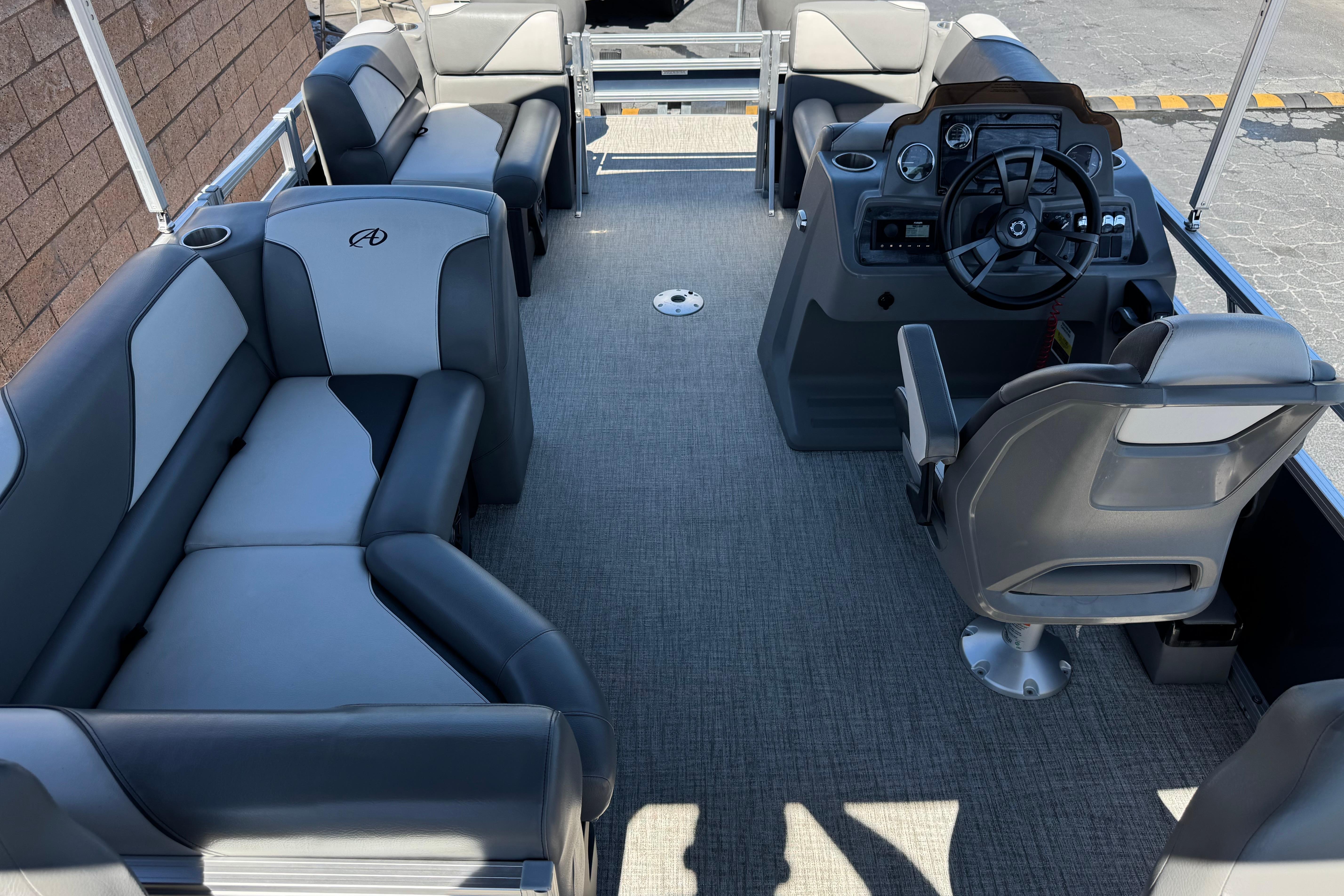 2023 Avalon Venture Fish N Cruise 20' pontoon boat interior with gray seating and helm.