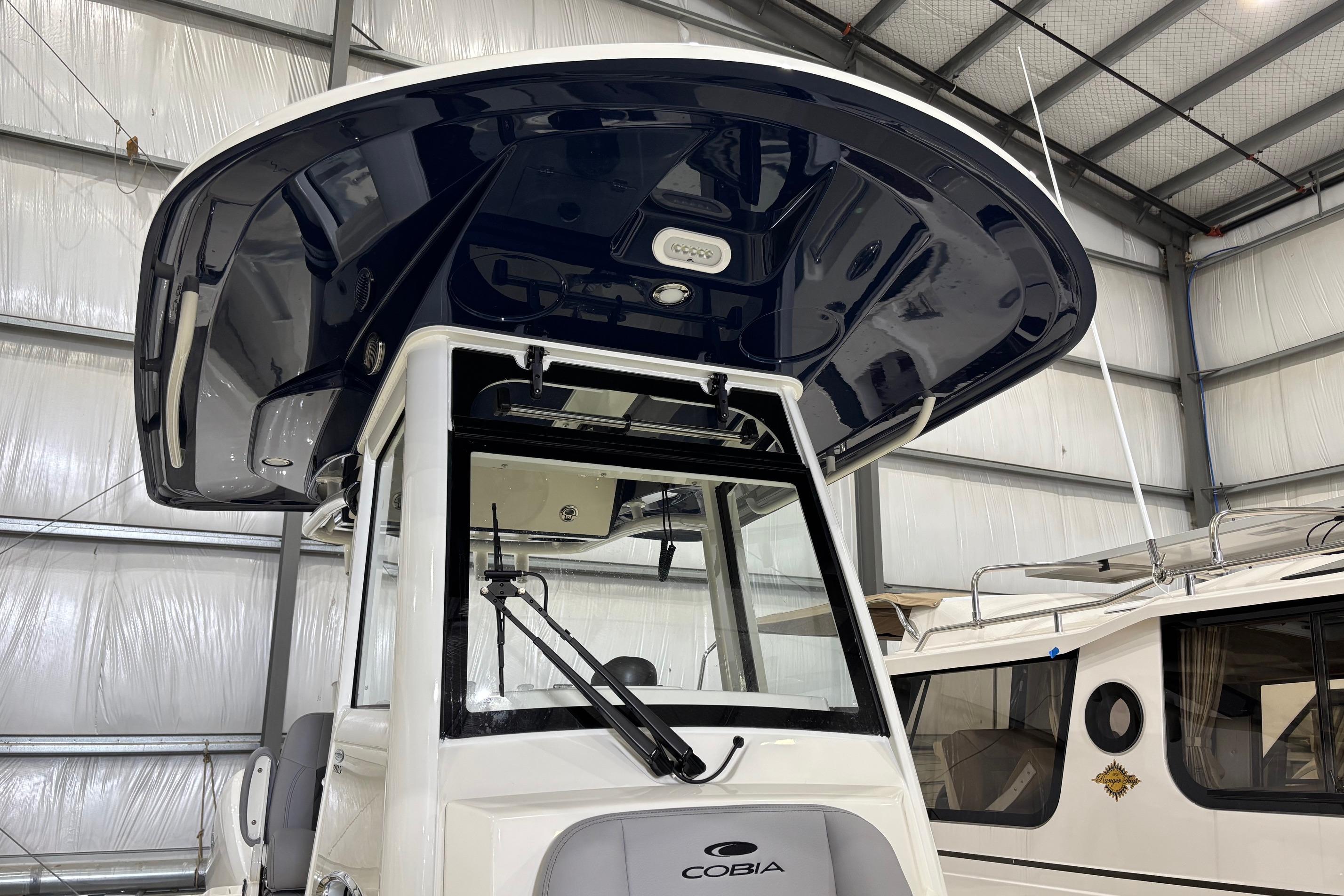 2026 Cobia 285 Open Center Console boat in a storage facility.