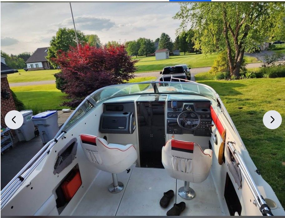 Interior view of a 1990 Regal Valante 225C boat in a garden.