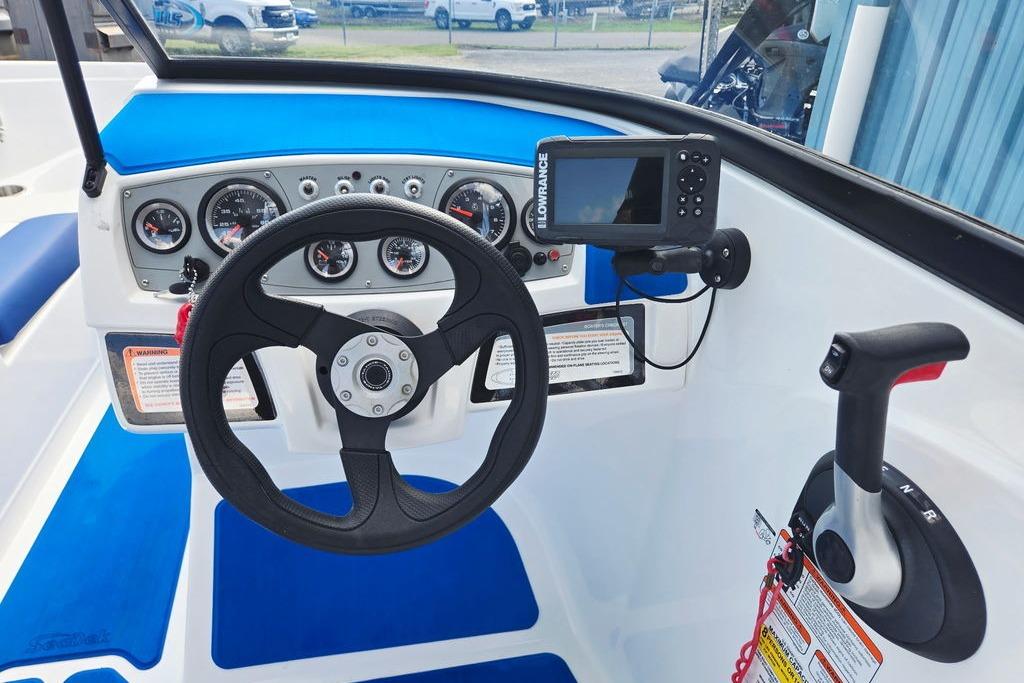 Cockpit of 2018 Tahoe 450 TS boat with steering wheel and control panel.